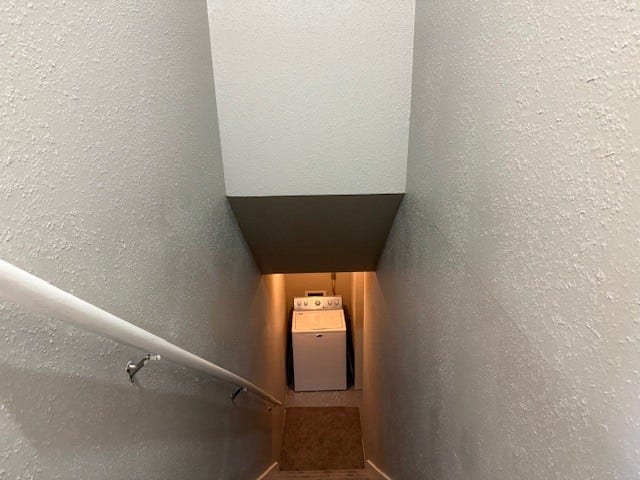6701 Sands Point Drive, #26, Houston, TX 77074 View of stairs leading down to garage and washer and dryer.