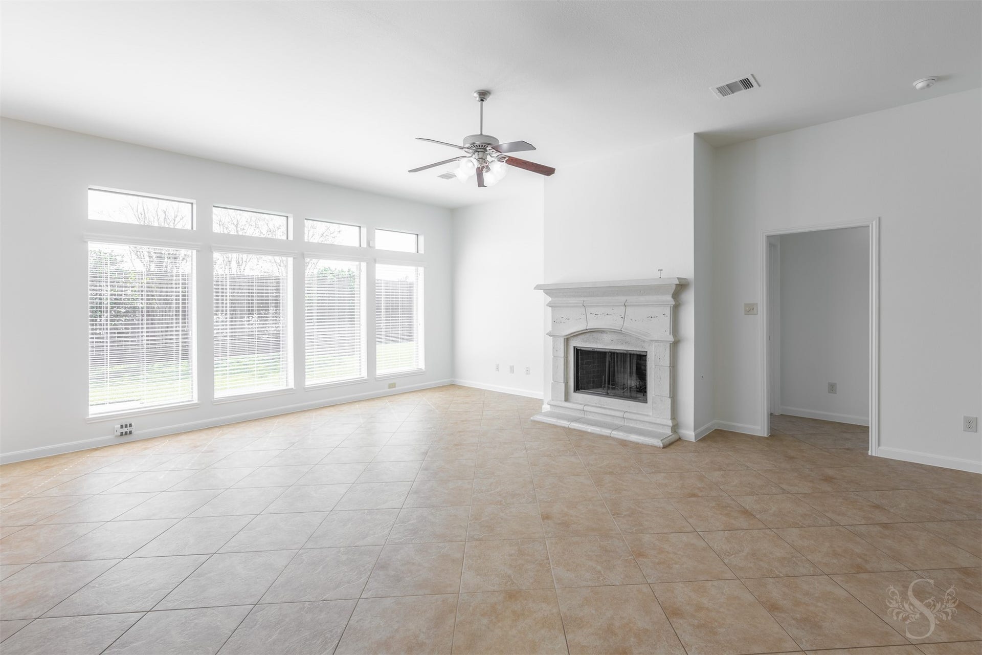 28015 Barberry Banks Lane, Fulshear, TX 77441 The spacious family room showcases a beautiful cast-stone fireplace and a wall of windows overlooking the back yard. High ceilings and diagonally laid tile flooring enhance this inviting space for everyday relaxation and entertaining friends.