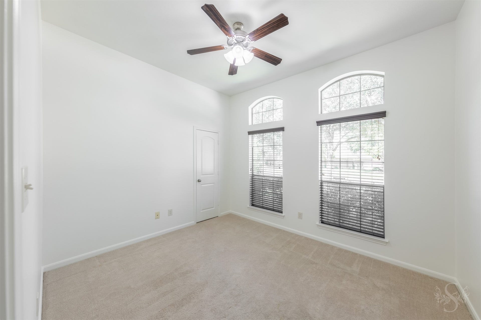 28015 Barberry Banks Lane, Fulshear, TX 77441 This secondary bedroom features elevated ceilings, plush carpeting and large windows that bring in soft natural light. Generous space and a comfortable layout make it ideal for family or guests.