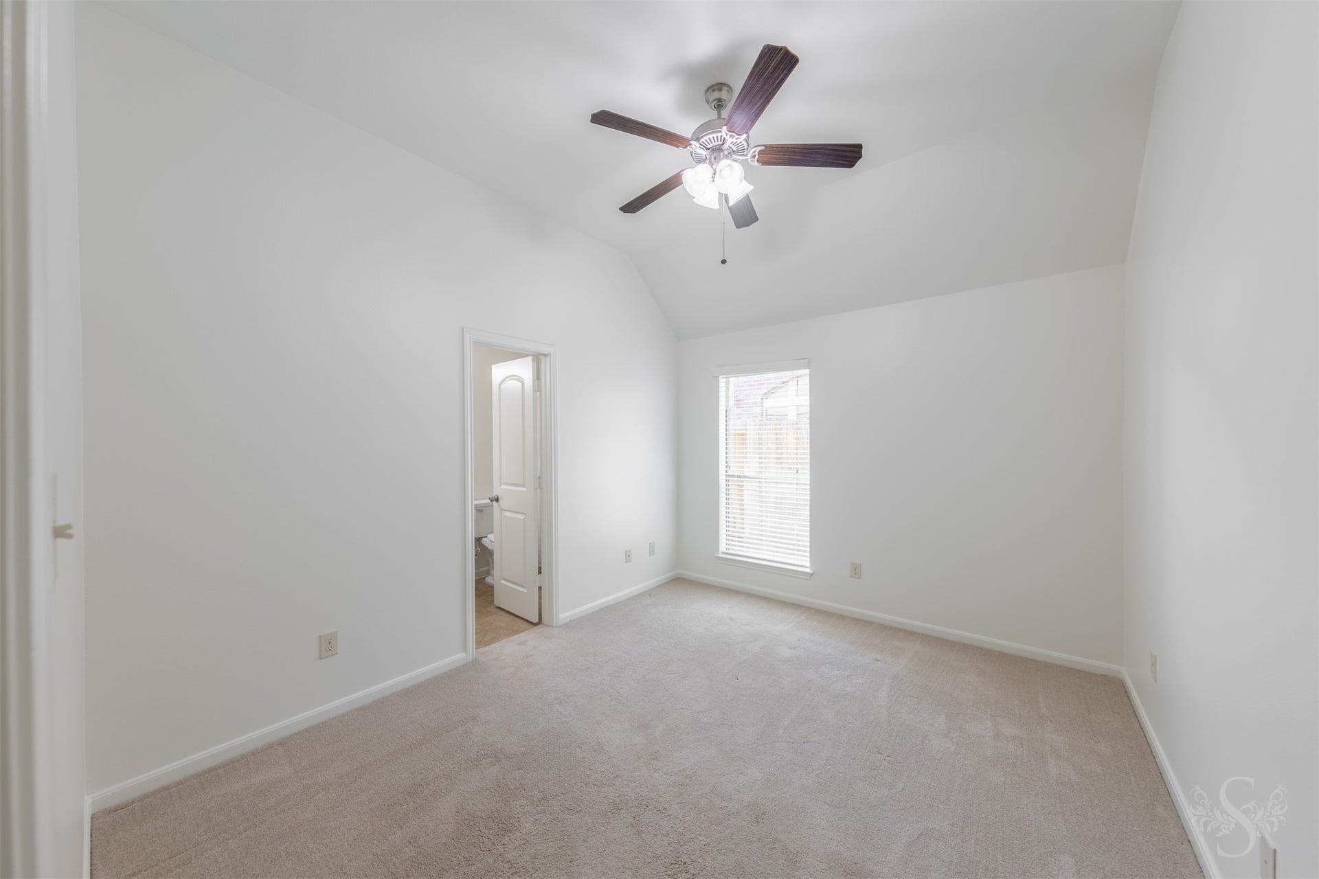 28015 Barberry Banks Lane, Fulshear, TX 77441 This secondary bedroom features elevated ceilings, plush carpeting and a window that bring in soft natural light. Generous space and a comfortable layout make it ideal for family or guests.