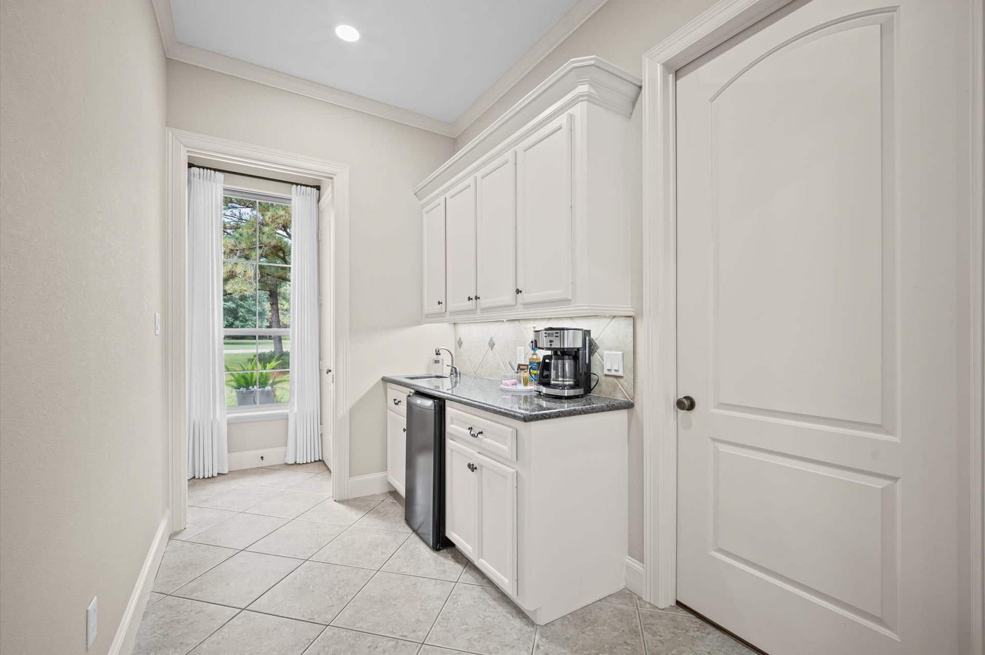 25815 Bridle Creek Drive S, Magnolia, TX 77355 Conveniently appointed utility area with cabinetry, counter space and beverage refrigerator