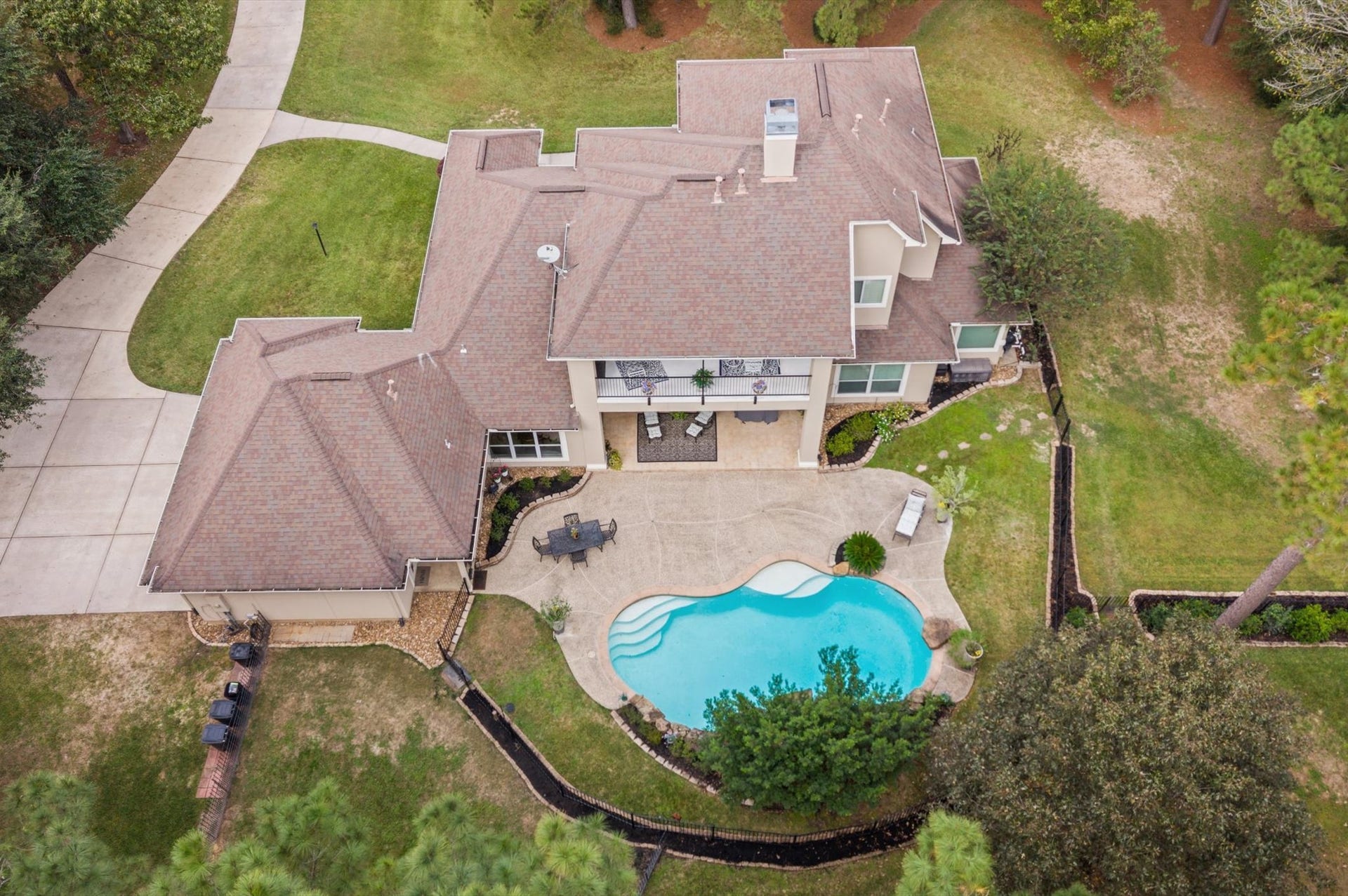 25815 Bridle Creek Drive S, Magnolia, TX 77355 Aerial view of the private pool and expansive outdoor living area