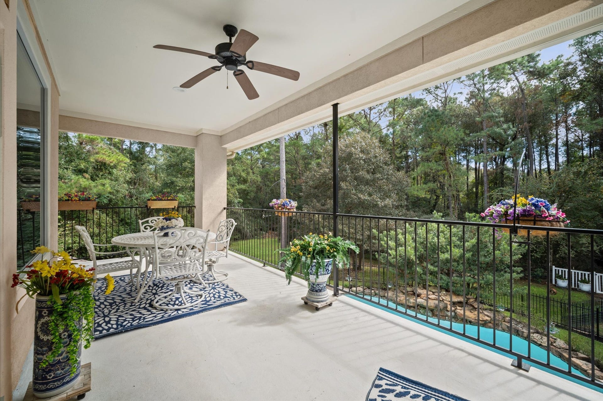25815 Bridle Creek Drive S, Magnolia, TX 77355 Covered upper-level balcony overlooking the pool and wooded backyard