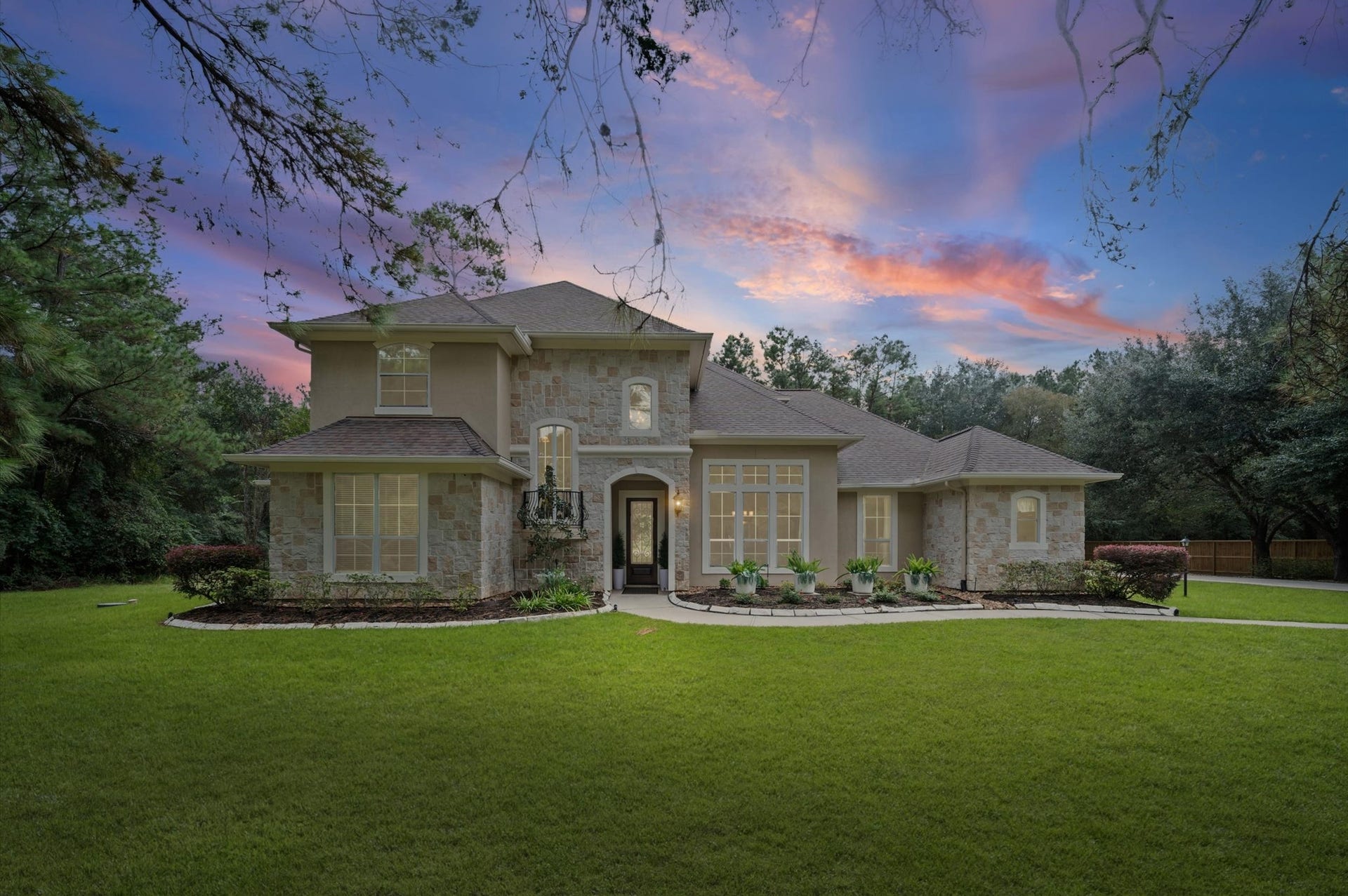 25815 Bridle Creek Drive S, Magnolia, TX 77355 Gorgeous twilight exterior showcasing the home's timeless architecture