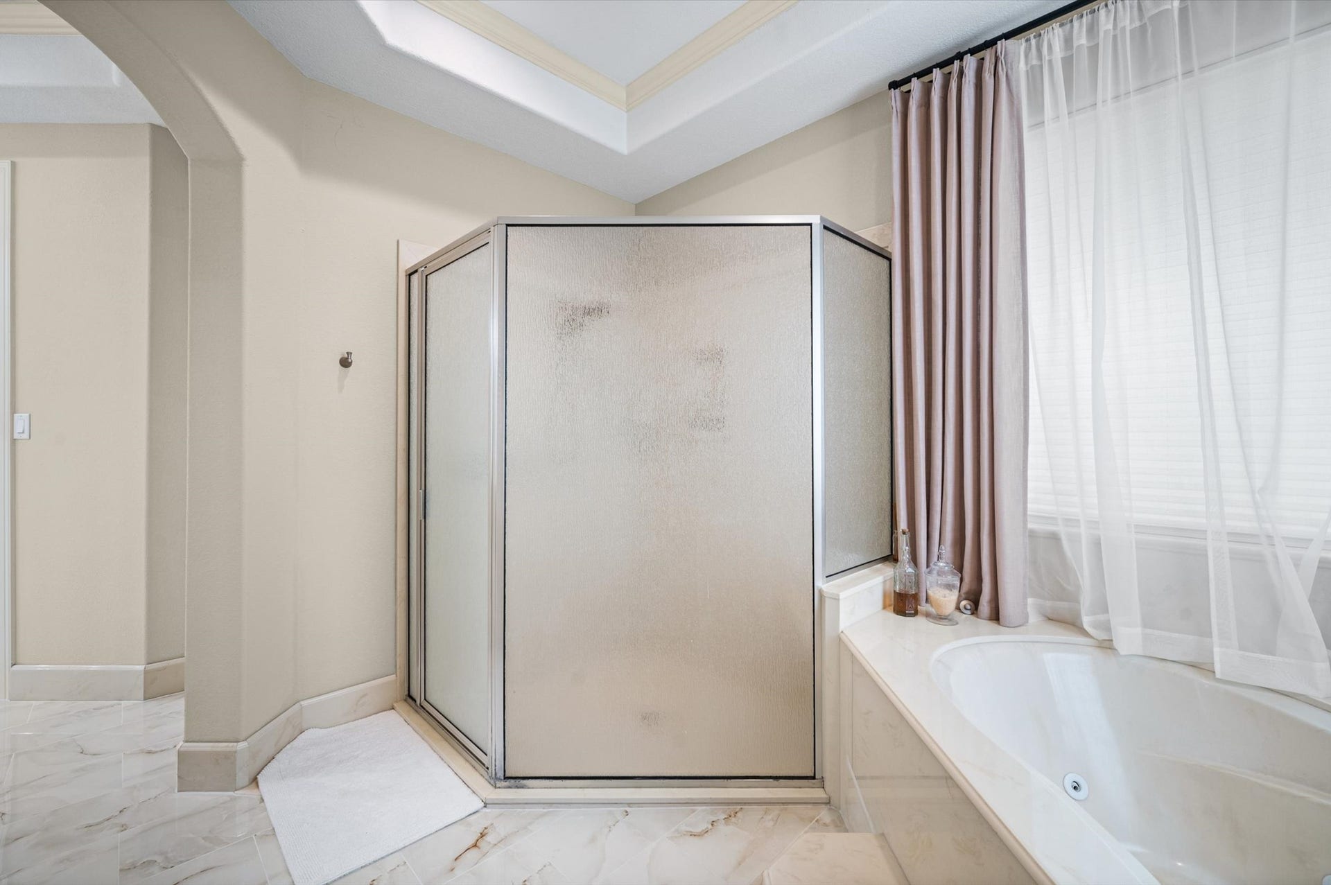 25815 Bridle Creek Drive S, Magnolia, TX 77355 Primary bath featuring a separate glass-enclosed shower and soaking tub