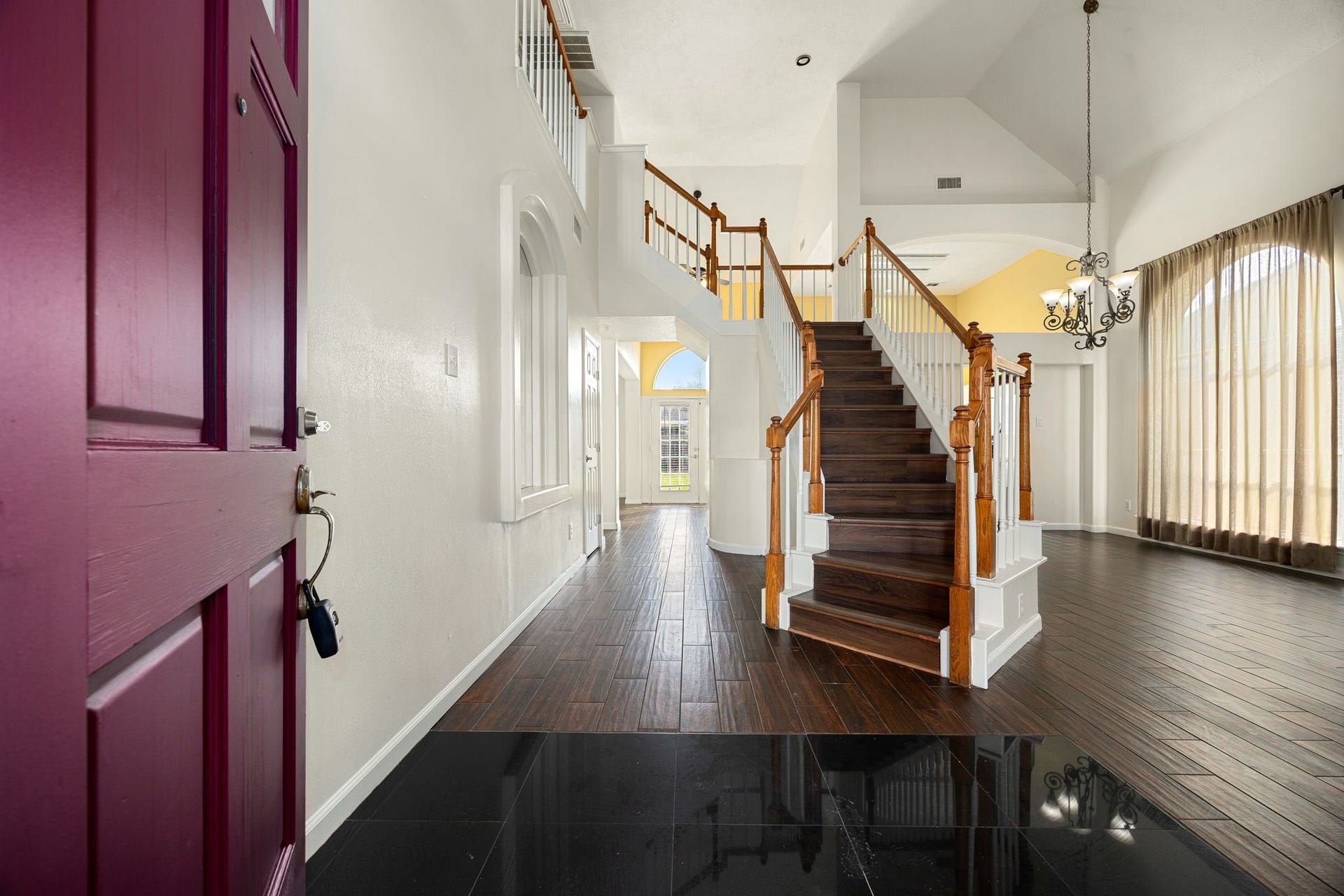 6306 Pago Lane, Houston, TX 77041 A dramatic two-story foyer welcomes you in, featuring a rich wood staircase, soaring ceilings, and an elegant chandelier that sets the tone for the home.