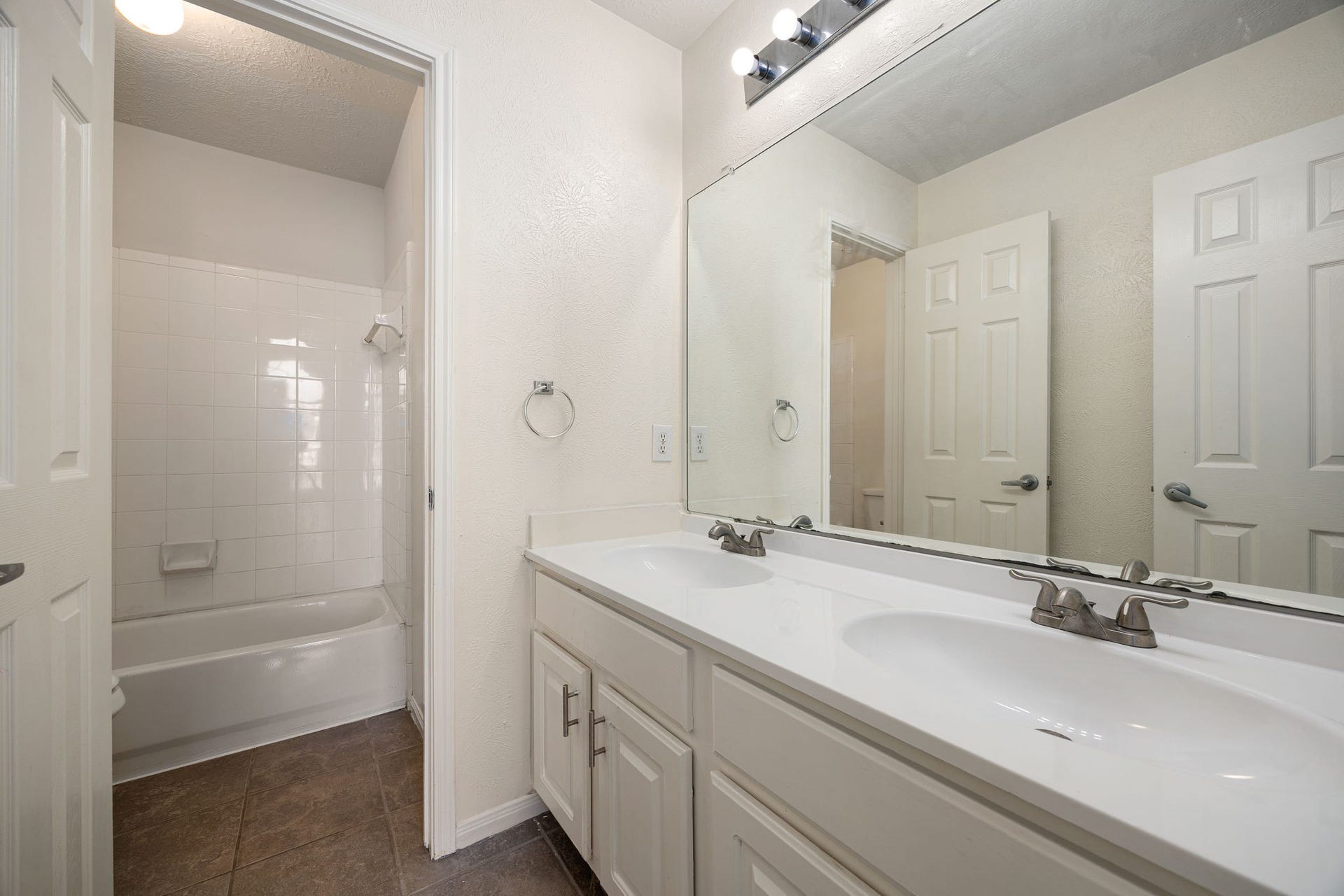 6306 Pago Lane, Houston, TX 77041 A secondary bathroom offers a tub-shower combo and dual-sink vanity, providing convenience for family or guests.
