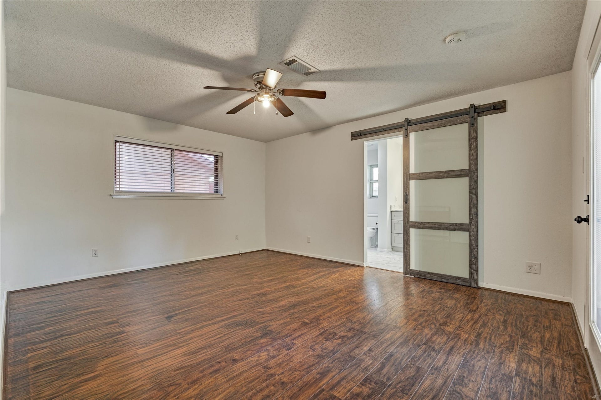 402 Shadywood Circle, Conroe, TX 77304 Spacious primary featuring an updated ensuite bathroom and private exterior access to the backyard.