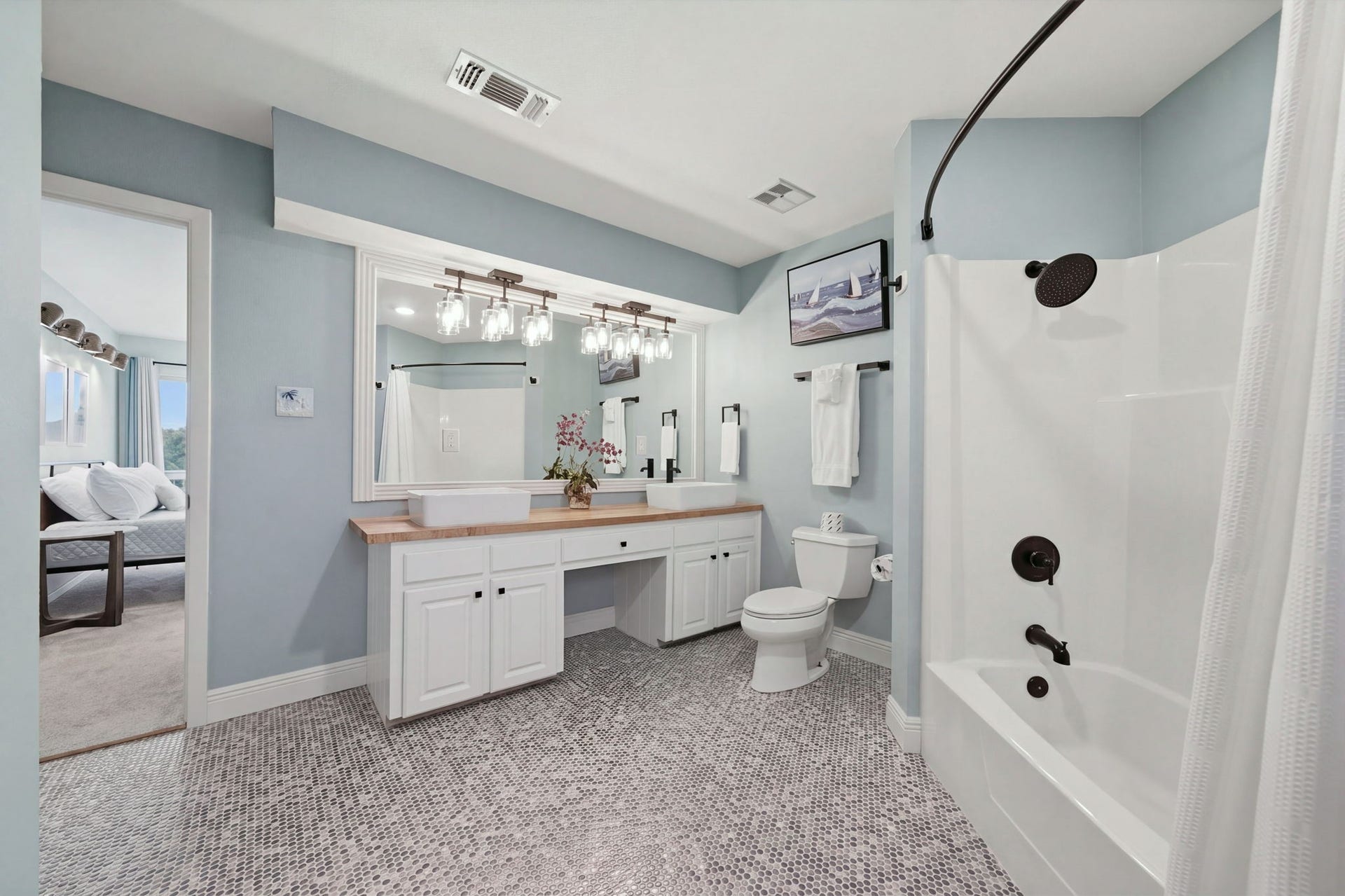 Primary bathroom with GORGEOUS remodel, includes built-in dresser & closet. The floor tile is stunning!