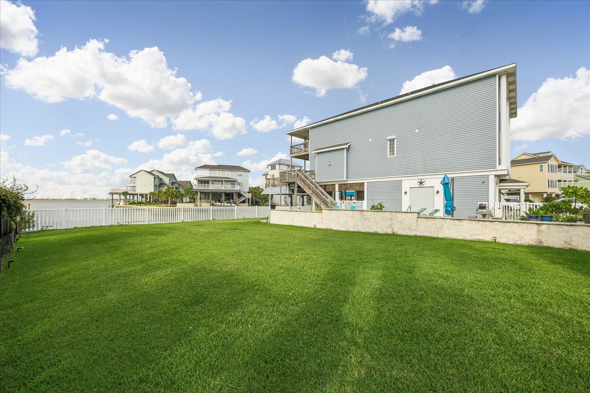 426 Sunset Circle, Tiki Island, TX 77554 Plenty of green space for outdoor activities, play, and enjoying time with your fur babies, all within the fully fenced property. Fresh landscaping has been added to the backyard.