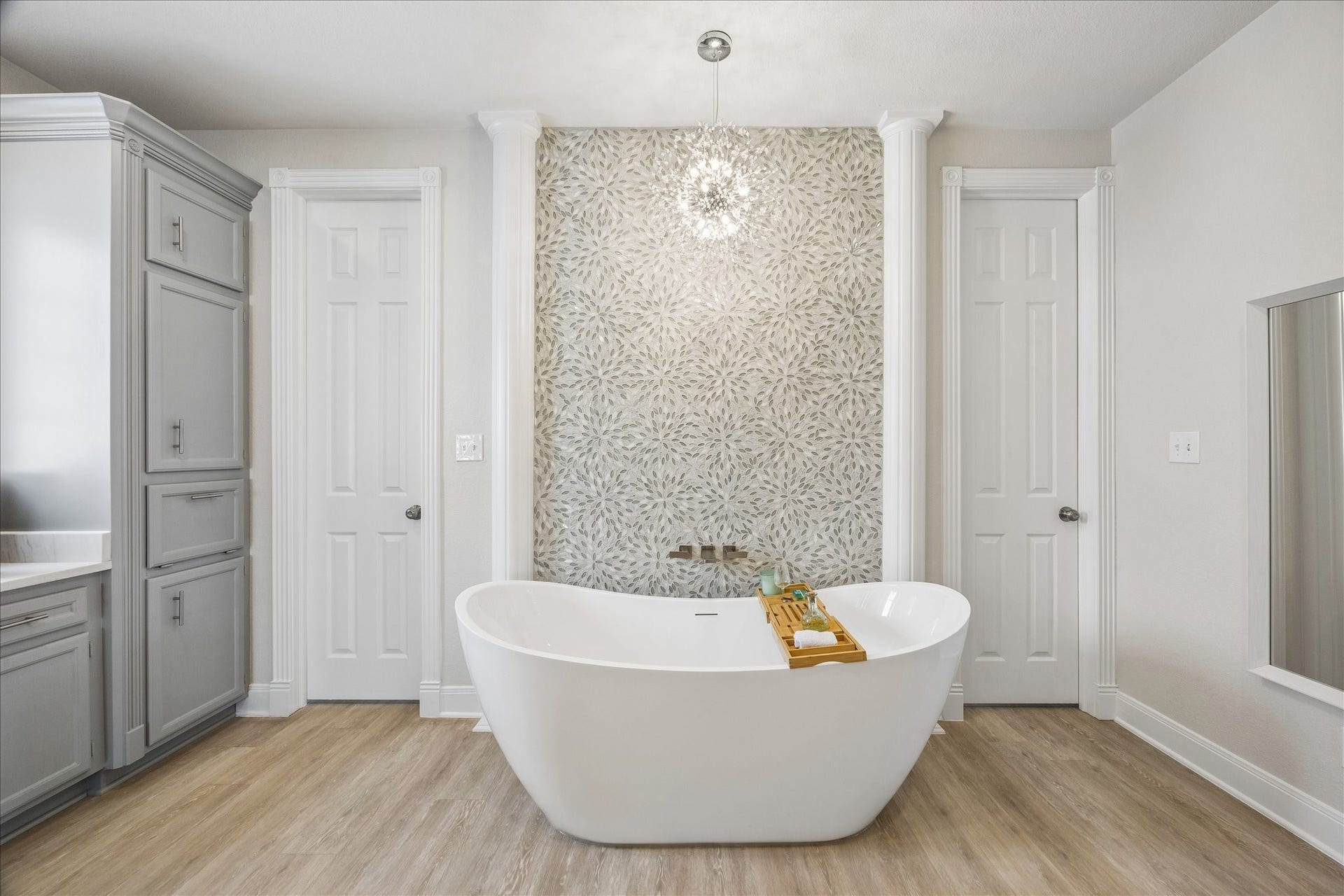 426 Sunset Circle, Tiki Island, TX 77554 Another view of the elegant soaking tub, highlighted by the custom tiled accent wall and refined finishes that create a relaxing focal point in the completely remodeled primary bathroom.