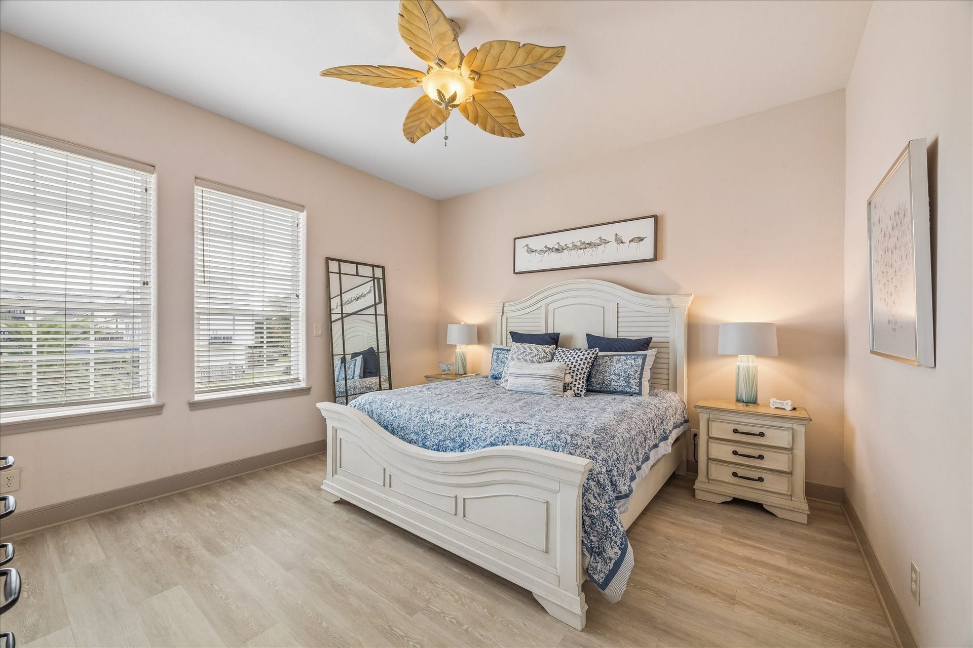 426 Sunset Circle, Tiki Island, TX 77554 Comfortable & spacious 2nd level guest bedroom with vinyl wood look flooring and a walk-in closet. Front-facing windows provide natural light and views overlooking the front of the home, with convenient access to a full bath.