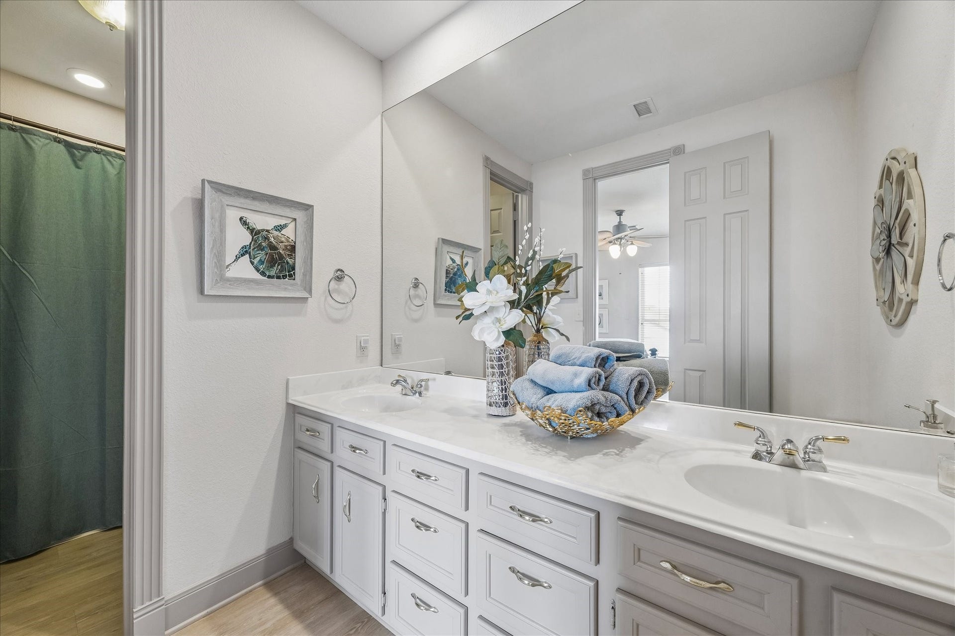 426 Sunset Circle, Tiki Island, TX 77554 3rd level guest bathroom featuring a dual vanity with ample cabinet storage, providing plenty of space and functionality for family and guests.