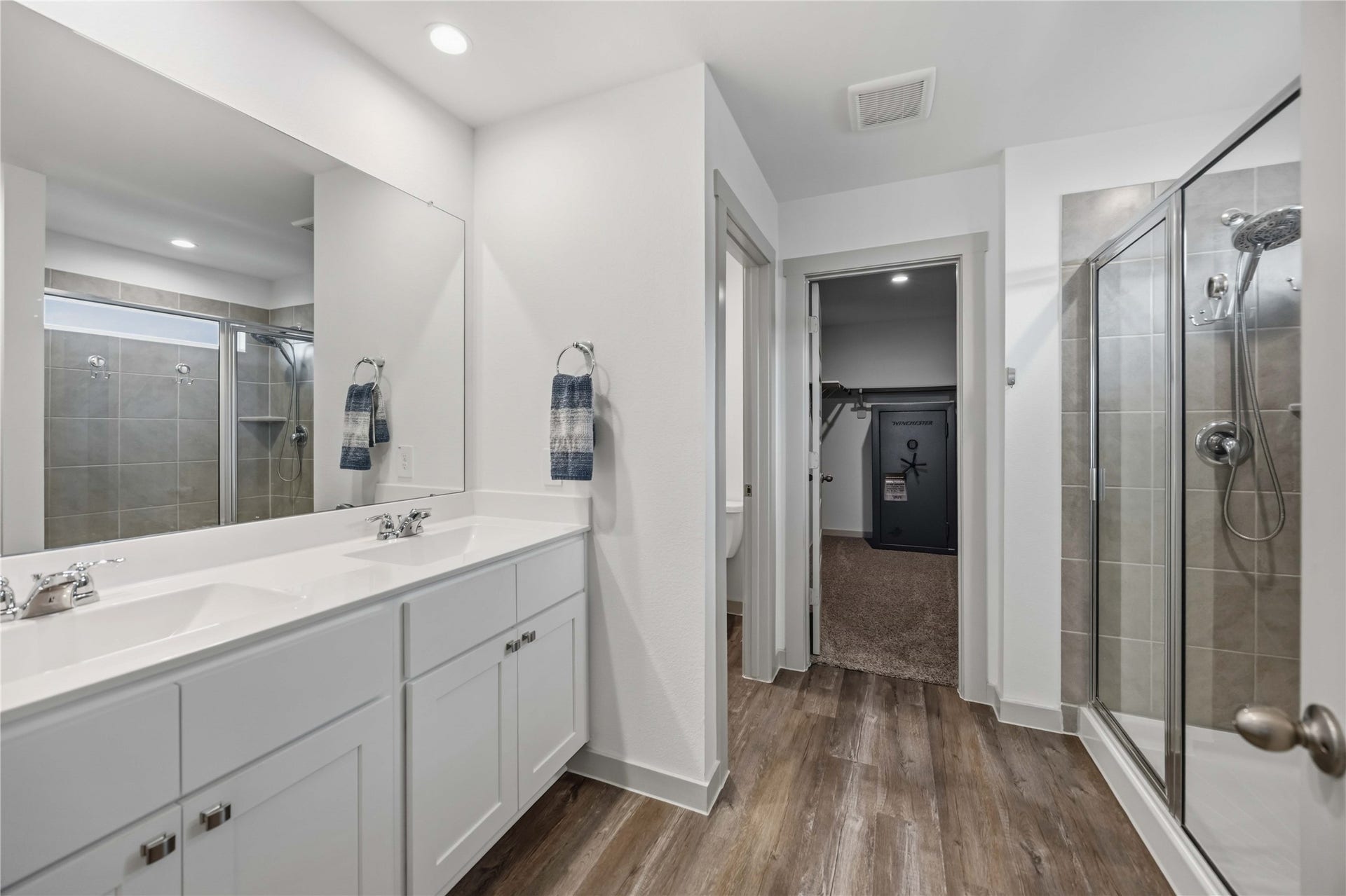 1029 Great Barracuda Lane, Alvin, TX 77511 The primary bath features and oversized stand alone shower with tile surround and double sink vanity.