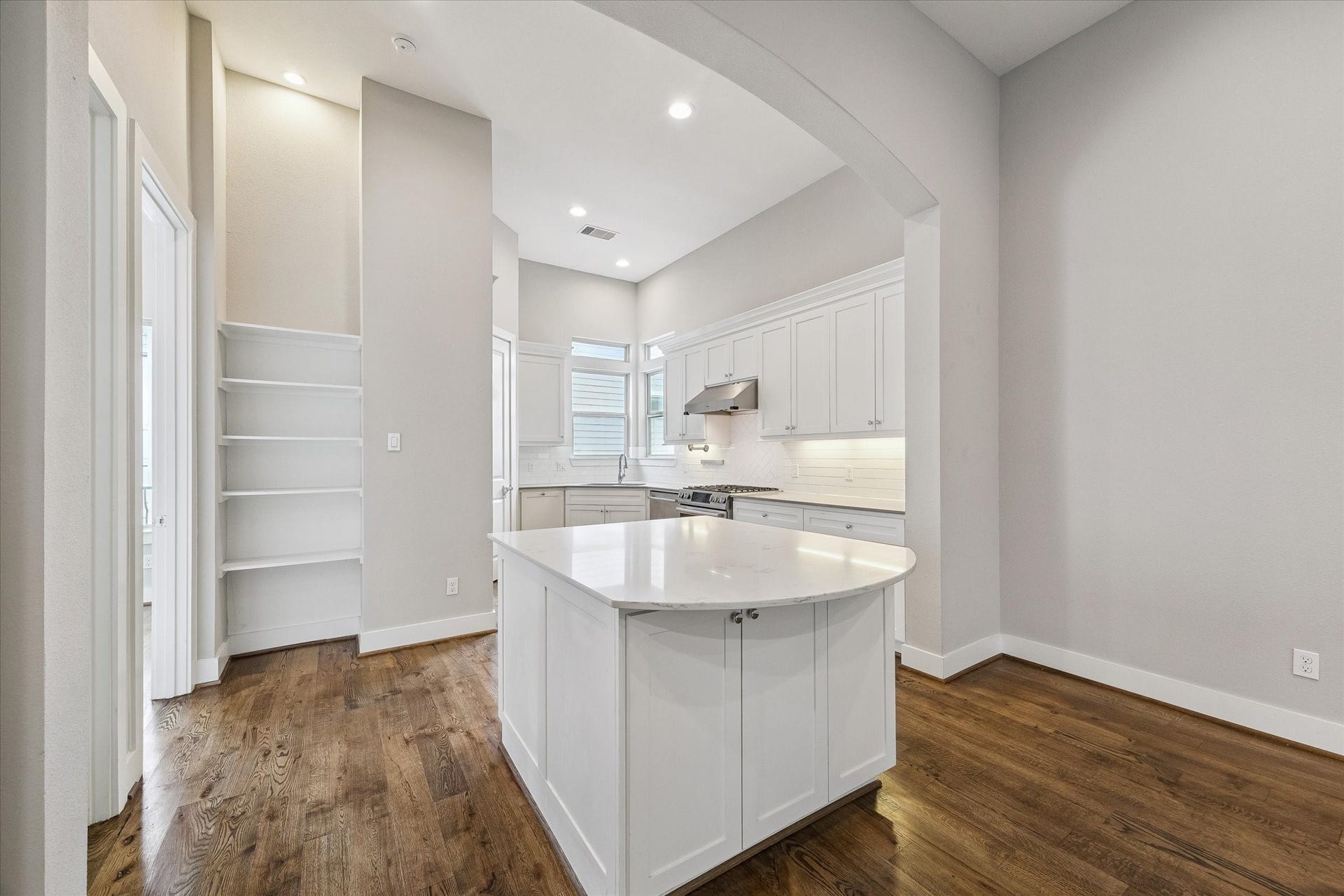 5743 Kiam Street, #F, Houston, TX 77007 Beautiful kitchen with an island, full pantry, and additional storage shelves.