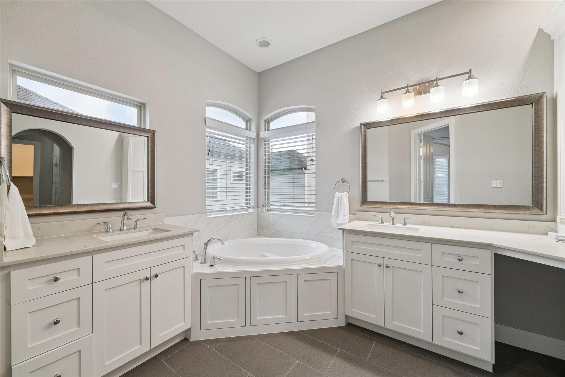 5743 Kiam Street, #F, Houston, TX 77007 Spa-like primary bathroom with separate sinks, a vanity, a soaking tub, a water closet, and a shower.
