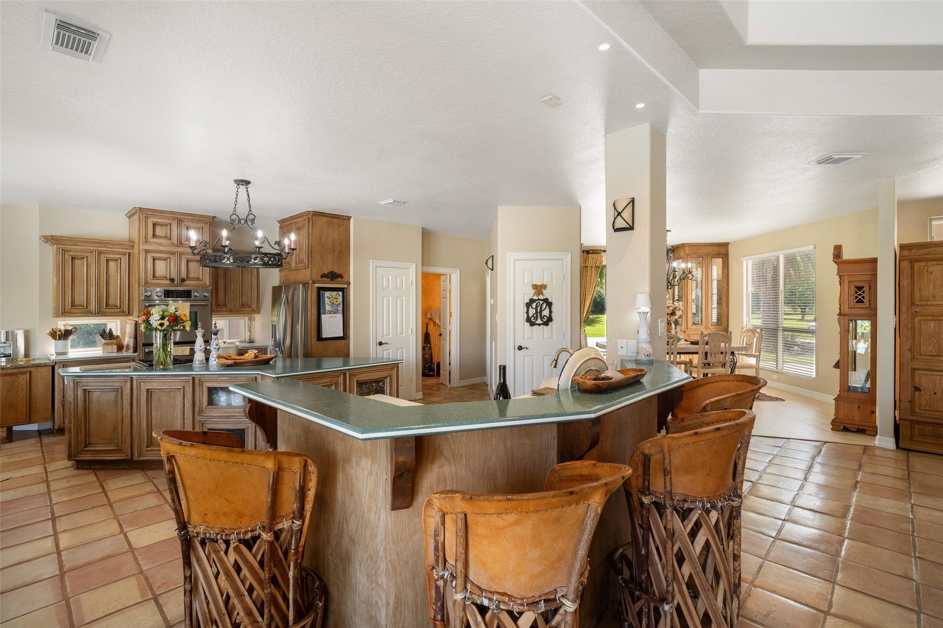 2150 Hewitt Street, League City, TX 77573 Beautiful kitchen with custom cabinets, grand island and bar top seating area