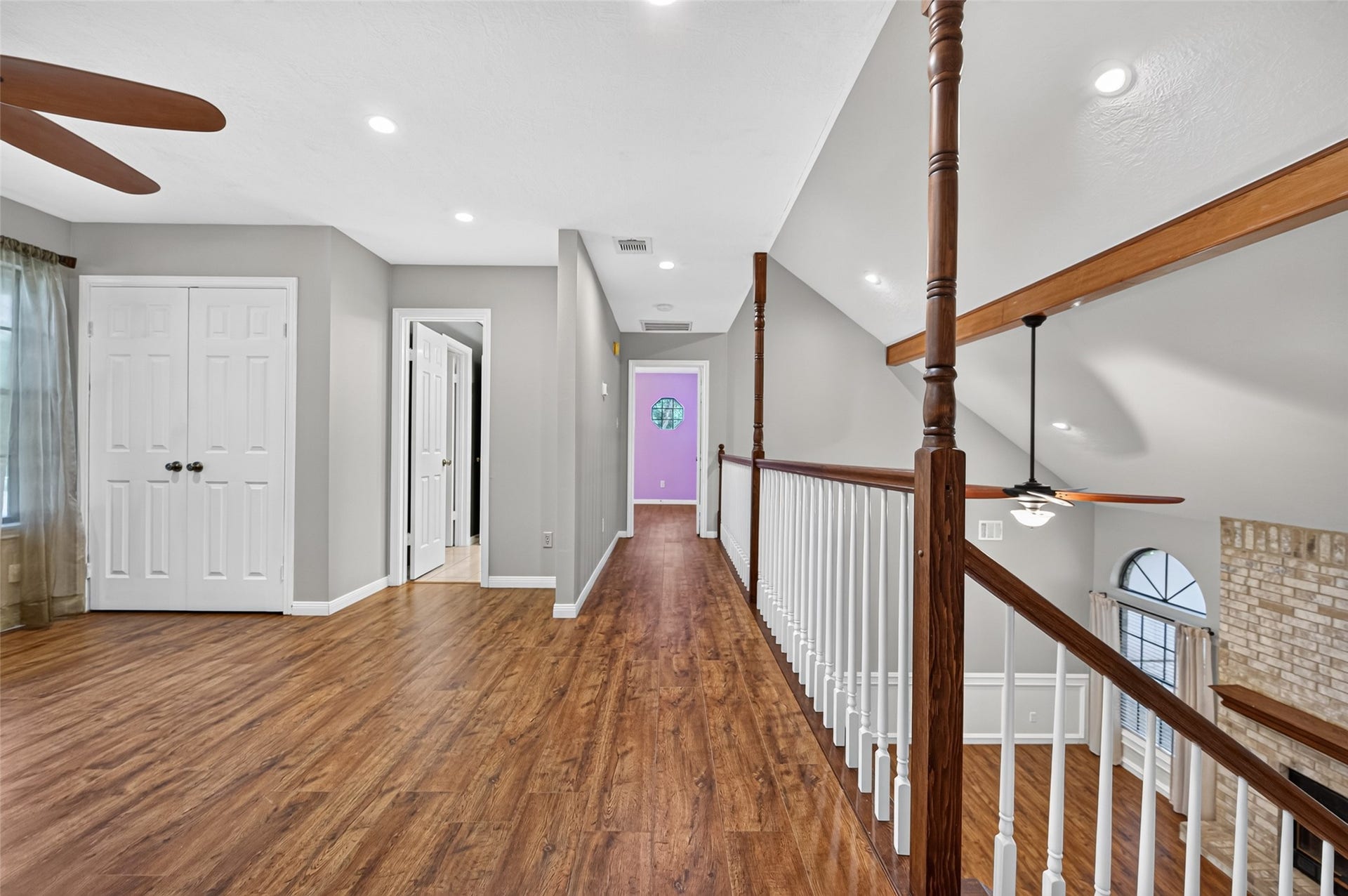 16405 Smith Street, Jersey Village, TX 77040 The second-floor landing highlights the home's open, airy design with views overlooking the Living Room below and bedrooms positioned at opposite ends of the upper level. Wood-look laminate flooring continues throughout much of the second floor for a cohesive, easy-care finish. Three zoned HVAC systems provide separate climate control for the main living areas, second floor, and expansive Game Room addition.