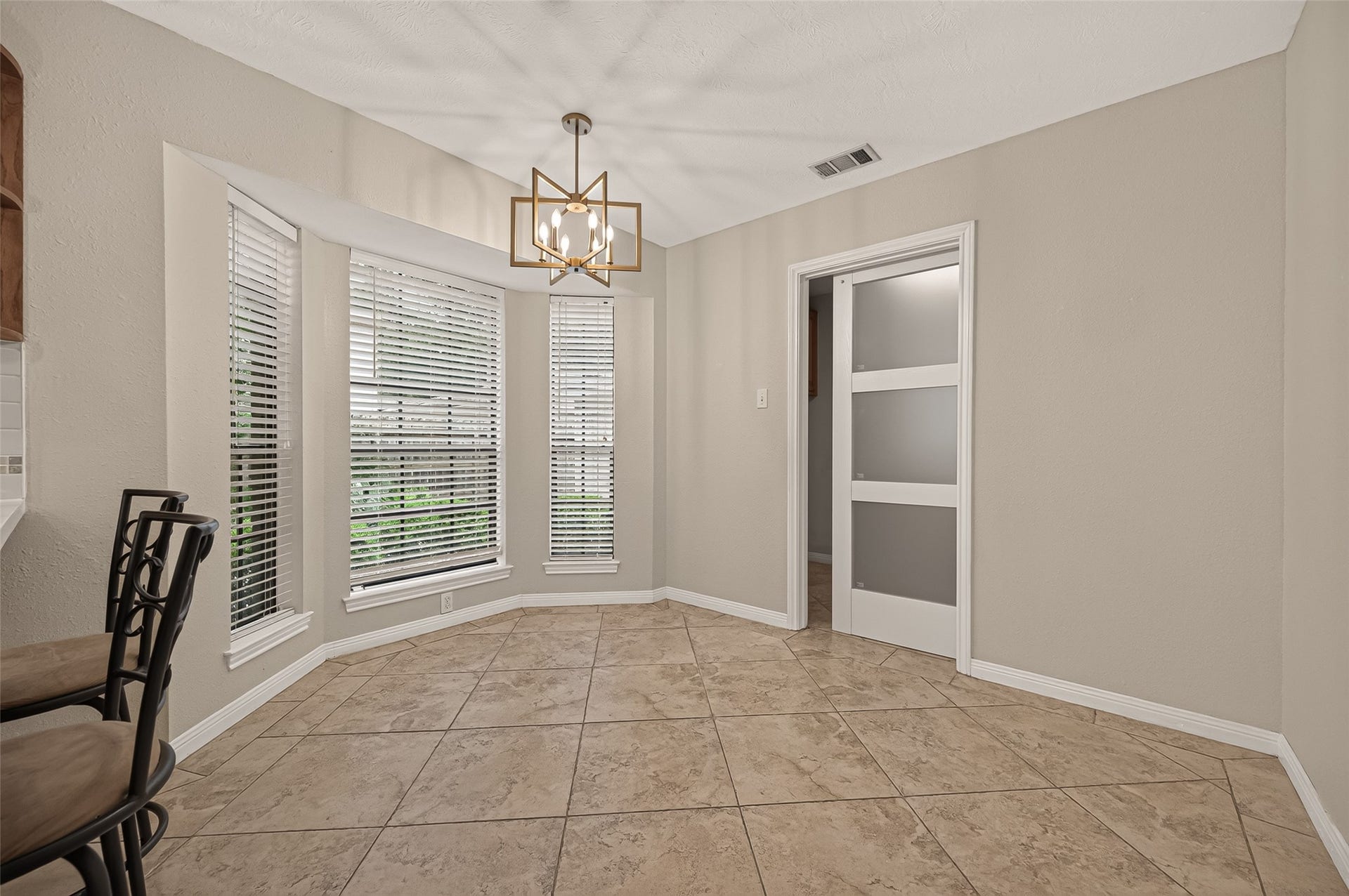 16405 Smith Street, Jersey Village, TX 77040 Imagine starting each morning with sunlight streaming through the bay window as you enjoy a cup of coffee before the day begins. This inviting breakfast nook offers the perfect setting for everyday meals, weekend pancakes, or helping with homework while dinner is on the stove. An updated designer light fixture adds a fresh touch, while its seamless connection to the kitchen makes gathering together feel effortless.