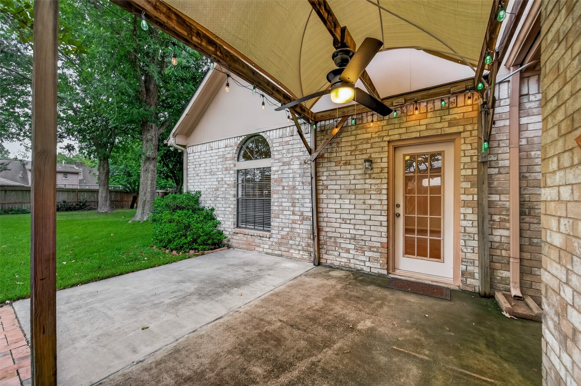 16405 Smith Street, Jersey Village, TX 77040 The covered pergola extends your living space outdoors with shade, a ceiling fan, and ambient caf lightingcreating the perfect setting for morning coffee, weekend barbecues, or relaxing with friends on warm Texas evenings. French door provide convenient access to the game room, making indoor and outdoor entertaining effortless.