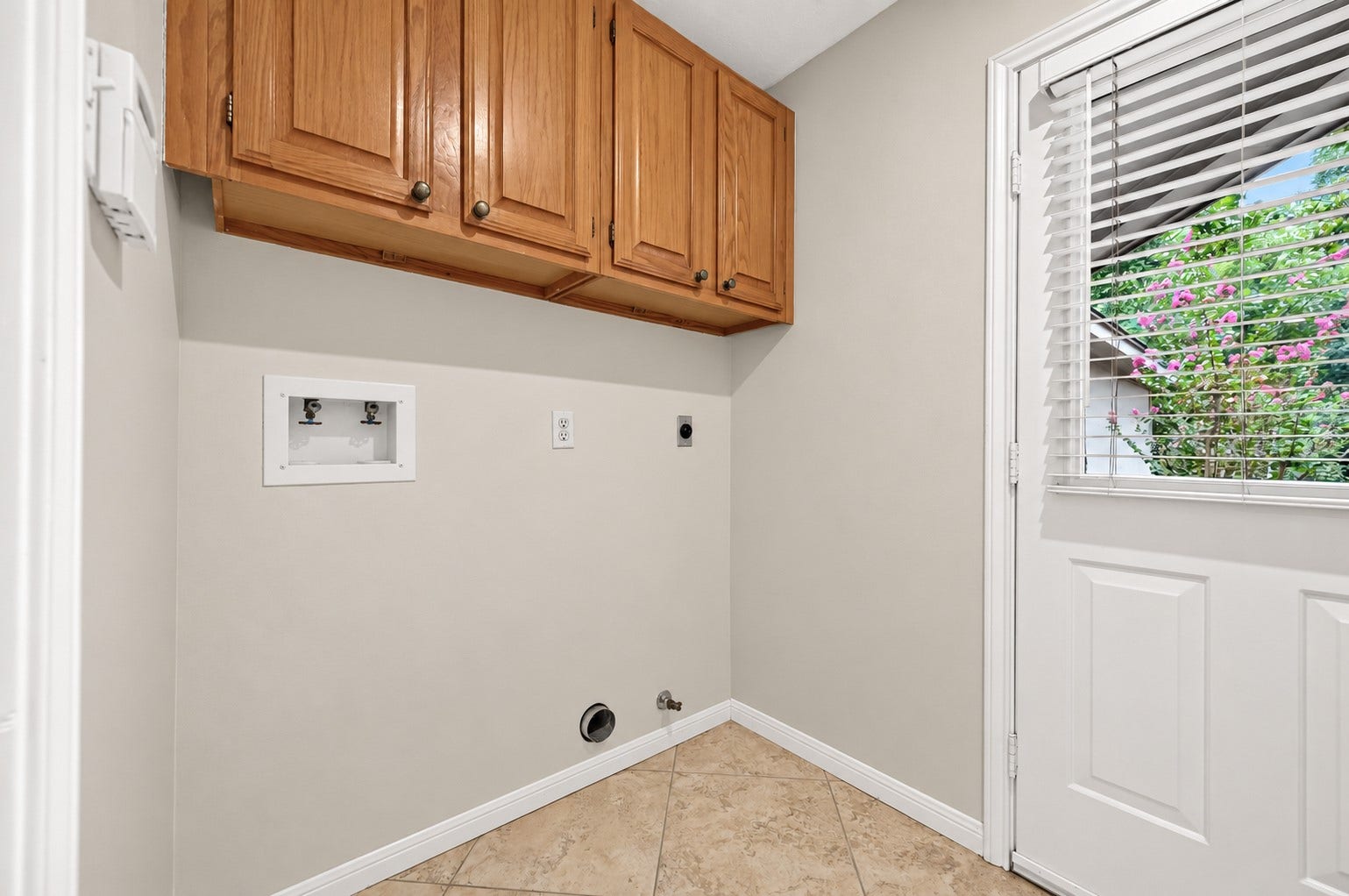 16405 Smith Street, Jersey Village, TX 77040 Tucked just beyond the kitchen, the utility room is designed for everyday convenience. Upper hardwood cabinets provide valuable storage for laundry essentials, while both gas and electric dryer connections offer flexibility for your preferred appliances. An exterior door provides easy access to the detached garage and backyardperfect after gardening, outdoor projects, or letting pets back inside.