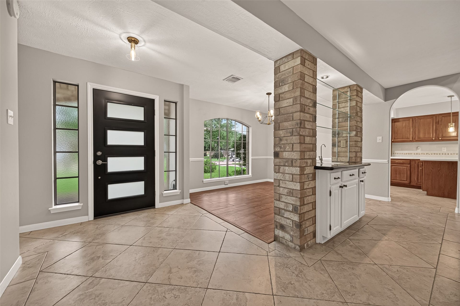 16405 Smith Street, Jersey Village, TX 77040 The moment you step inside, it's easy to see this home was designed to bring people together. The welcoming foyer offers inviting views into the dining room, kitchen, and wet bar, creating an easy flow that's equally suited for everyday family life and entertaining friends. Two coat closets immediately introduce the thoughtful storage you'll discover throughout the home, while easy-care flooring extends throughout with no carpet, making maintenance simple and creating an allergy-friendly environment.