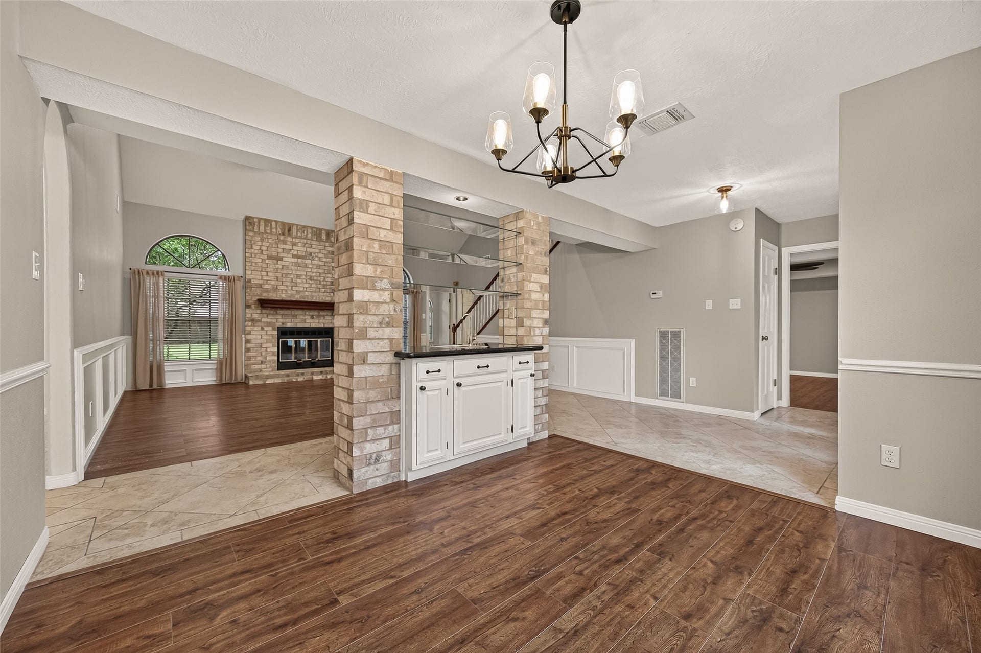 16405 Smith Street, Jersey Village, TX 77040 Designed with entertaining in mind, the adjoining wet bar features granite countertops, storage cabinetry, a sink, and glass display shelves, creating a natural transition between the dining room and family room. The expansive countertop easily serves as a buffet for holiday meals, a beverage station, or a convenient serving area for appetizers and desserts, while the display shelves offer the perfect place to showcase glassware, serving pieces, or seasonal dcor.