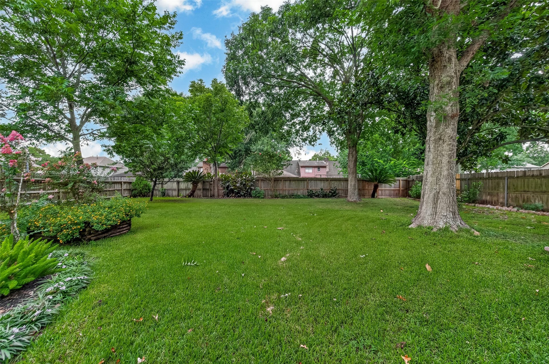 16405 Smith Street, Jersey Village, TX 77040 Whether you're tossing a football, setting up a volleyball net, planting a garden, or hosting family gatherings, this spacious backyard offers the kind of open green space that's becoming increasingly difficult to find. Towering mature trees provide beauty and welcome afternoon shade.