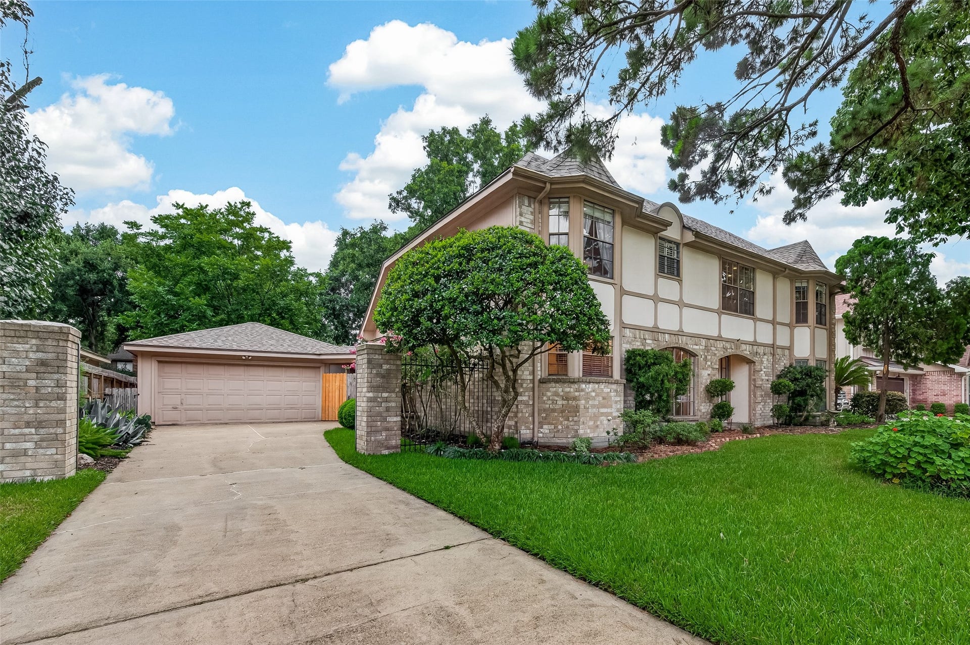 16405 Smith Street, Jersey Village, TX 77040 Nestled on an impressive 12,800-square-foot lot, this classic residence combines enduring curb appeal with quality construction, including a brick and Hardie exterior, gutters, and a roof replaced in 2023 for added peace of mind. The long driveway offers abundant parking for family and guests, leading to a detached two-car garage with automatic openermaking holiday gatherings, birthday celebrations, and everyday living just a little more convenient.