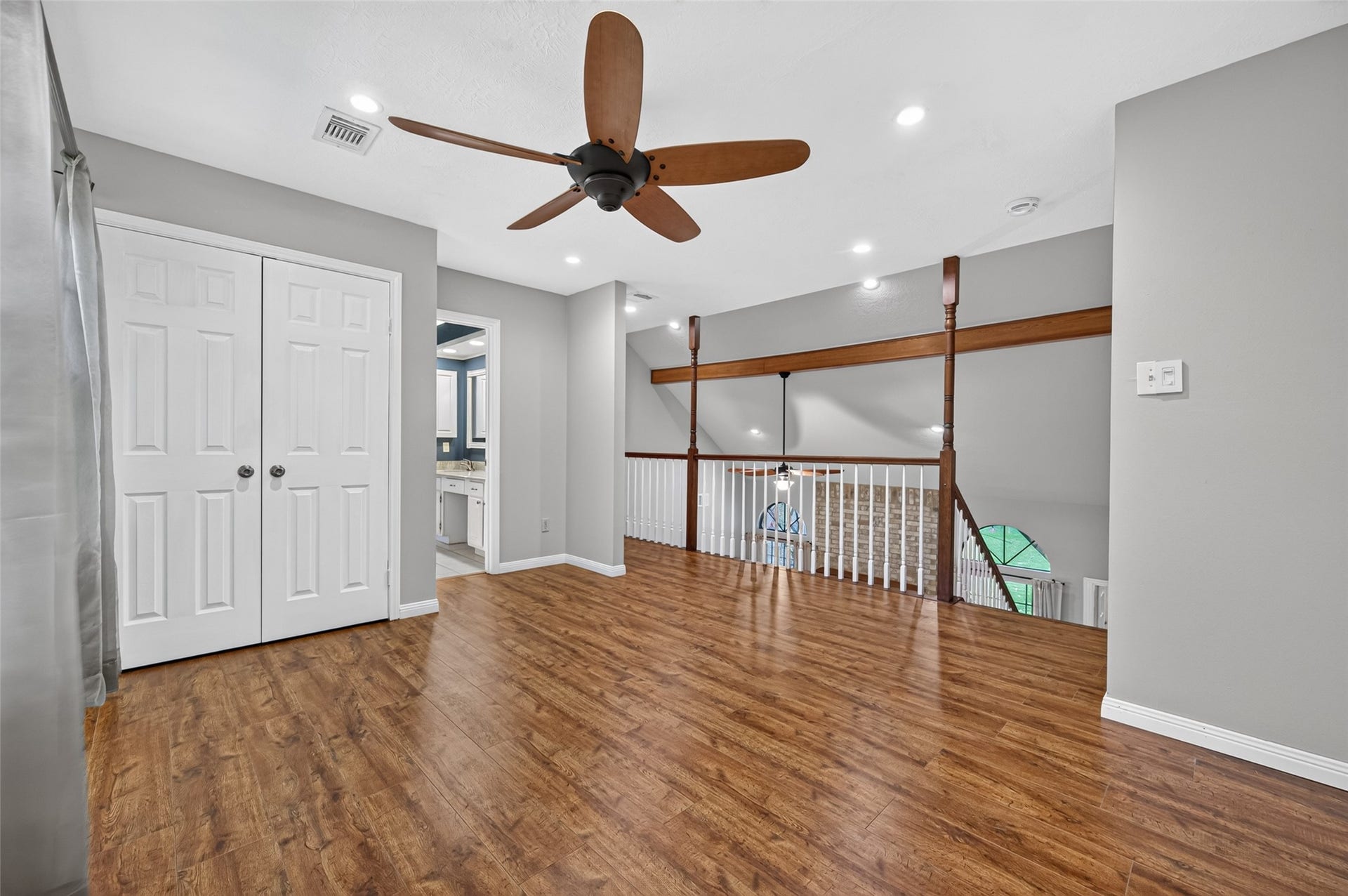 16405 Smith Street, Jersey Village, TX 77040 The staircase leads to a spacious second-floor flex area situated between Bedrooms 2 and 3. Featuring a ceiling fan, recessed lighting, and a convenient storage closet, this adaptable space is perfect for a homework station, reading retreat, gaming area, or casual lounge. The open railing overlooks the living room below, enhancing the home's open-concept design and allowing natural light to flow throughout.