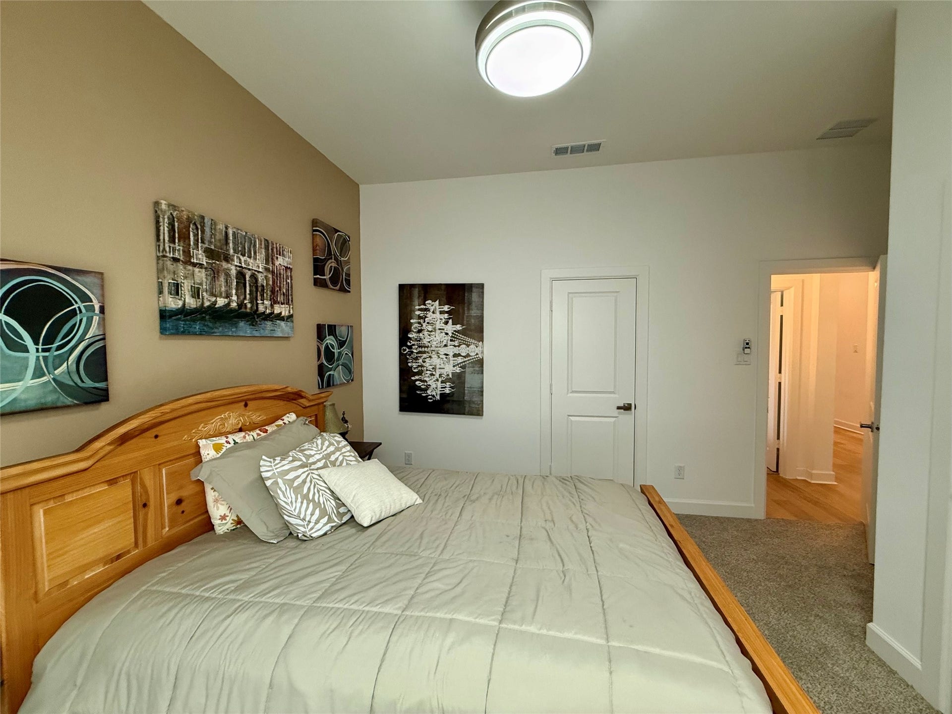 9911 Deep Water Drive, Missouri City, TX 77459 Cozy bedroom(3) with a wooden bed frame, modern lighting, and tasteful wall art, offering a serene retreat.