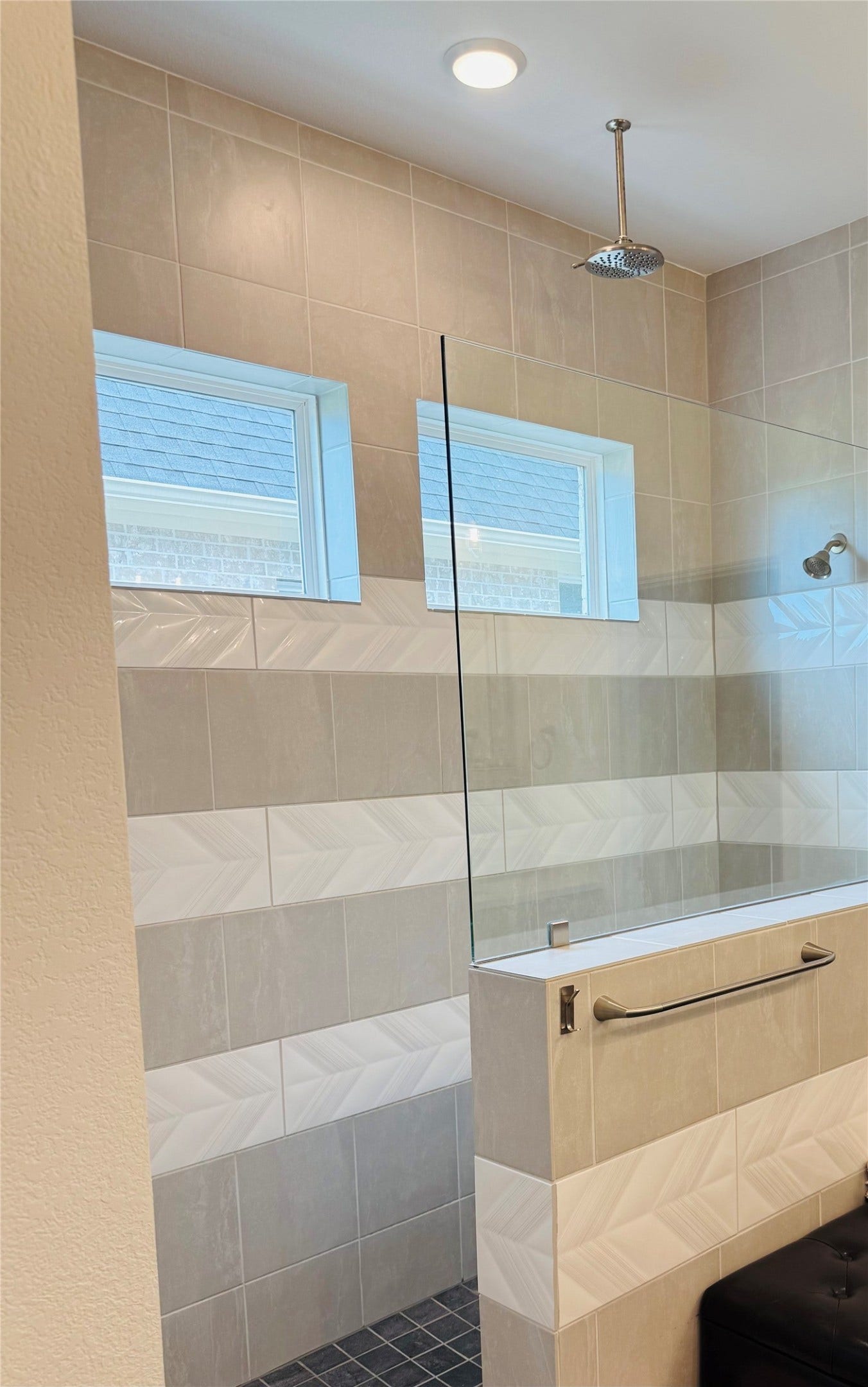 9911 Deep Water Drive, Missouri City, TX 77459 Elegant walk-in shower featuring modern tiling, dual windows for natural light, and a sleek overhead rain showerhead for a spa-like experience.