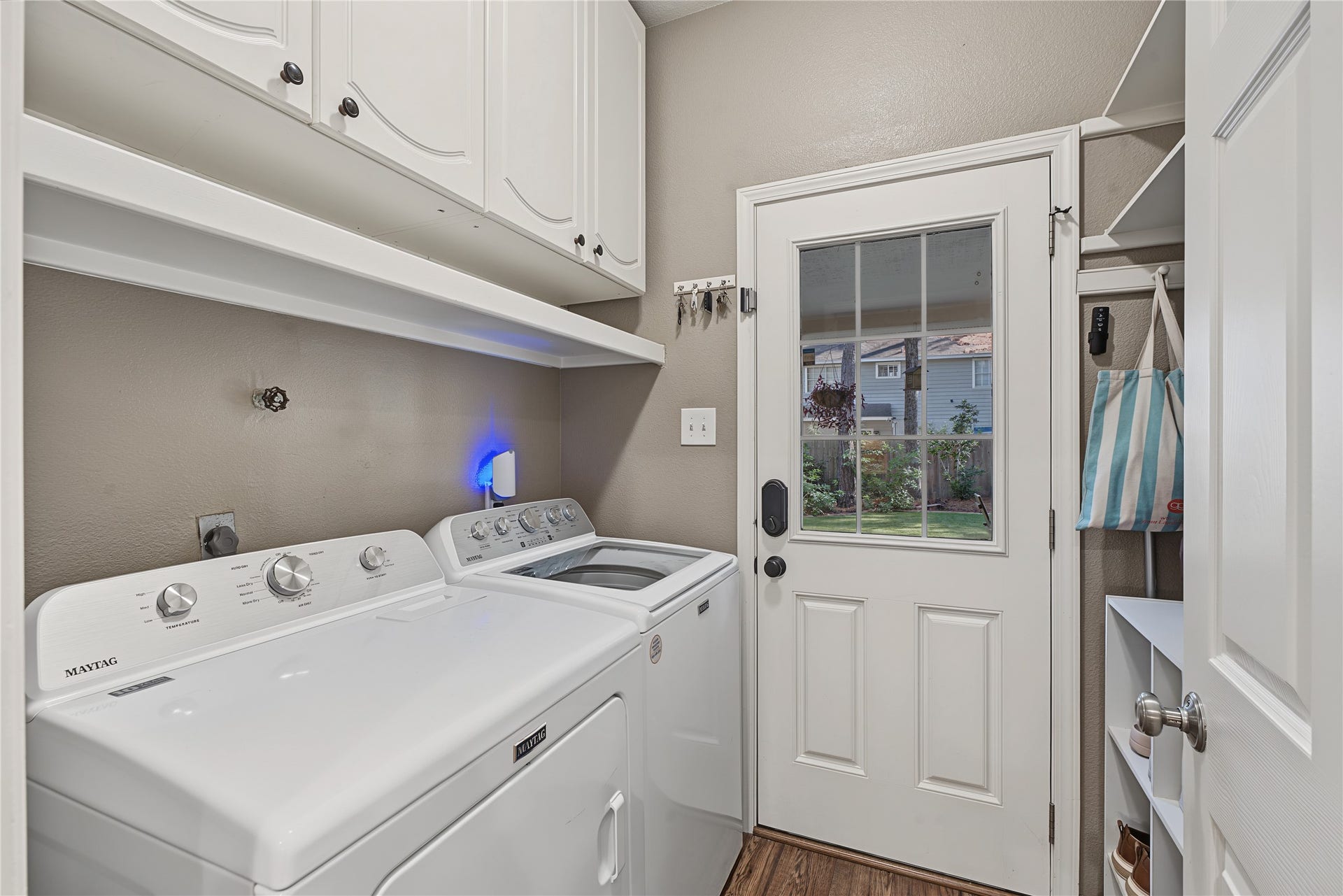 5 Otter Pond Place, The Woodlands, TX 77381 Laundry room with door to back yard and plenty of cabinetry for additional storage.