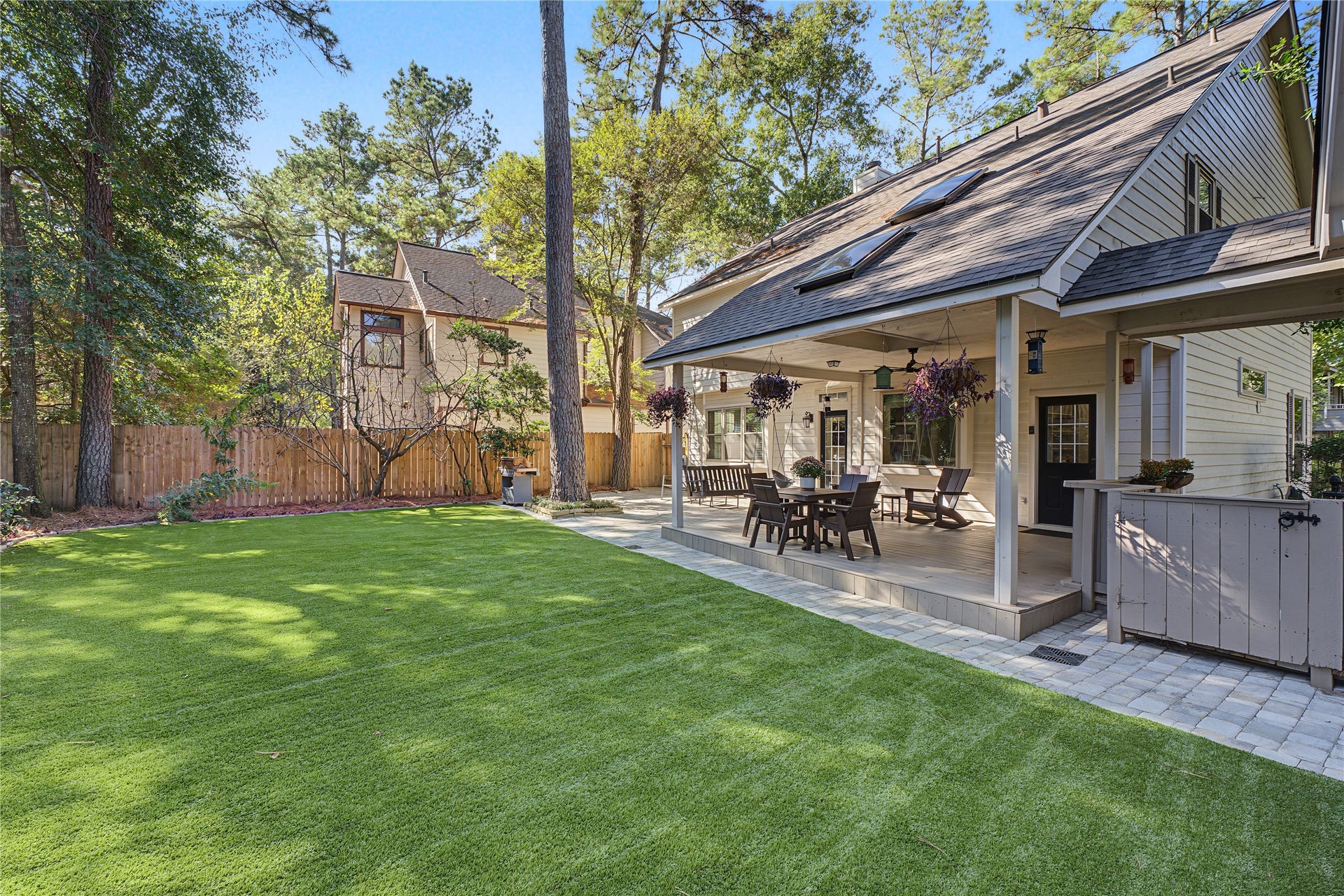 5 Otter Pond Place, The Woodlands, TX 77381 Stunning backyard oasis featuring low-maintenance artificial turf for effortless outdoor living.