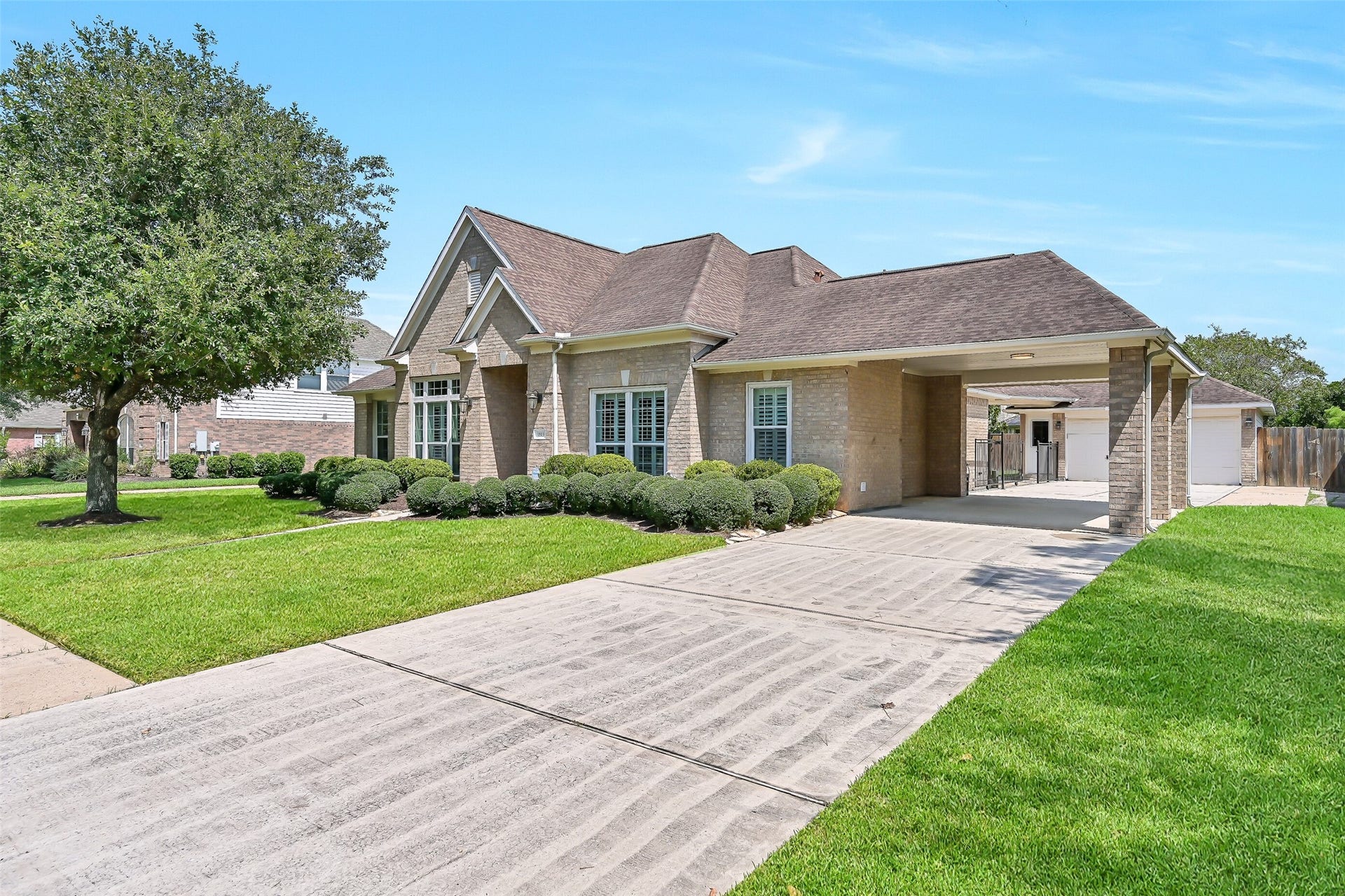 1813 Sandy Lake Drive, Friendswood, TX 77546 A wide driveway leads beneath the impressive porte-cochre, providing convenient covered access to the home while continuing through to the detached 2-car garage. This thoughtful setup adds both function & architectural interest to the oversized homesite.