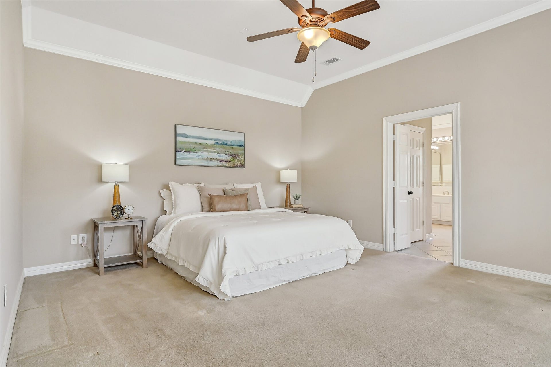 1813 Sandy Lake Drive, Friendswood, TX 77546 Tucked privately away from the secondary bedrooms, the spacious primary suite offers a raised ceiling with crown molding, fresh neutral paint & plenty of room for a complete bedroom ensemble, with direct access to the beautifully renovated en-suite bath.