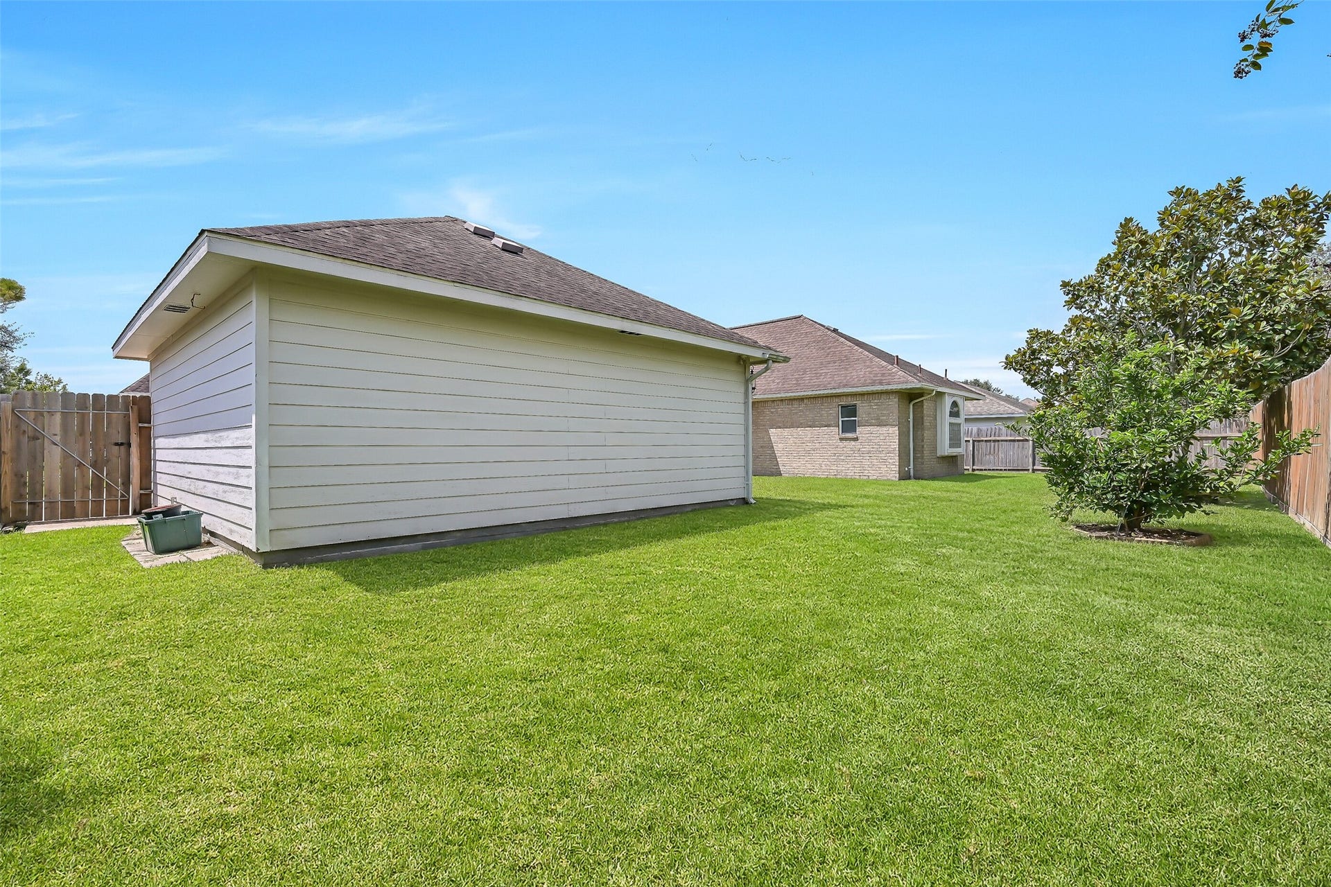 1813 Sandy Lake Drive, Friendswood, TX 77546 Beyond the patio, the oversized .27-acre homesite provides a surprisingly spacious fenced backyard with lush lawn & mature landscaping. The detached garage sits well away from the home, leaving plenty of open green space to enjoy.