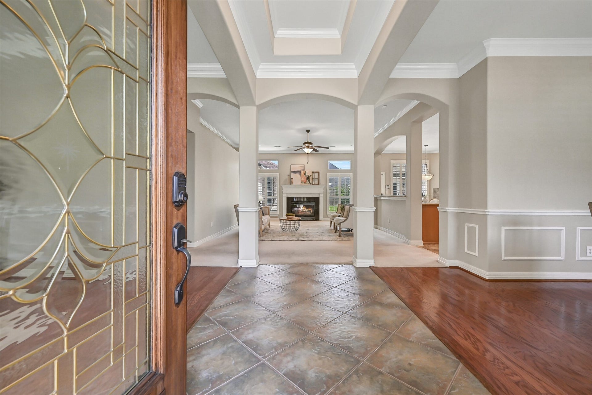 1813 Sandy Lake Drive, Friendswood, TX 77546 Step through the leaded-glass front door into an impressive entry with a raised ceiling, crown molding & a series of graceful arched openings that introduce the home's open, spacious design. Rich wood and tile flooring define the adjoining living spaces.