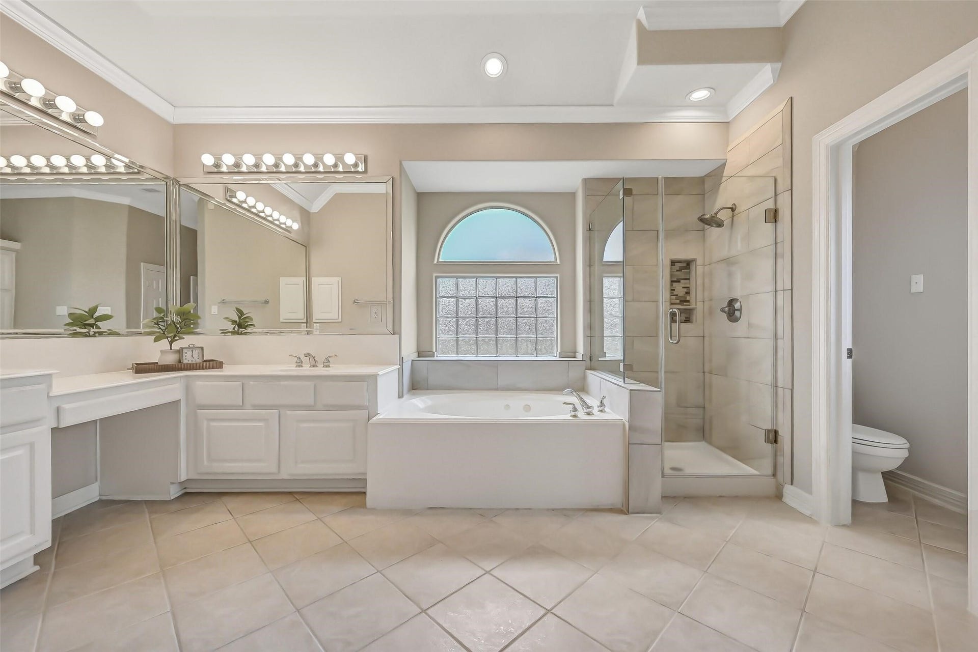 1813 Sandy Lake Drive, Friendswood, TX 77546 The secluded primary suite is complemented by this beautifully renovated bath featuring a jetted soaking tub, oversized seamless-glass shower, dual vanity areas & a private water closet, plus separate walk-in closets for exceptional storage.