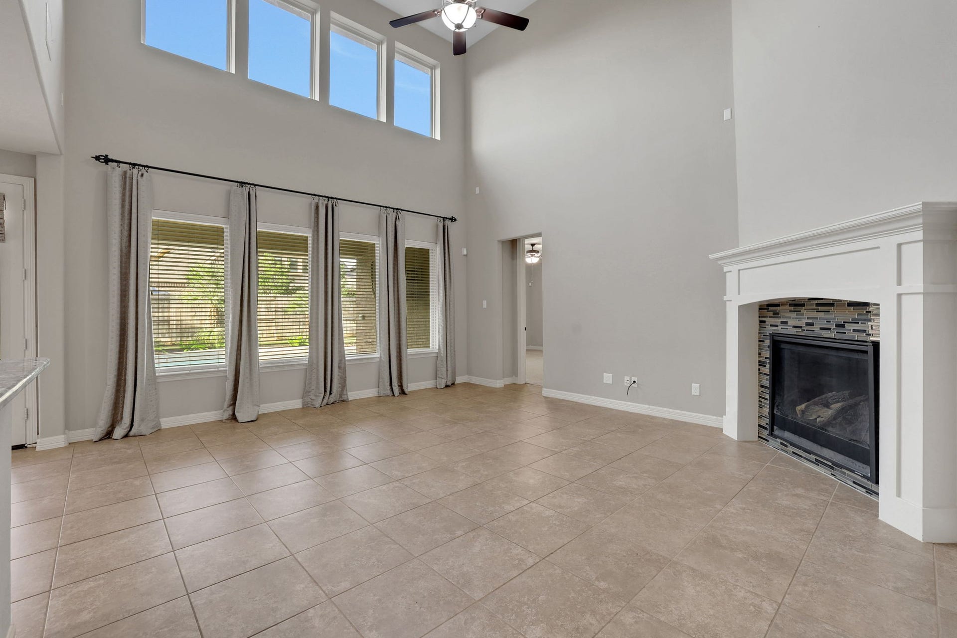 The family room features a wall of windows for an abundance of natural light and a charming fireplace