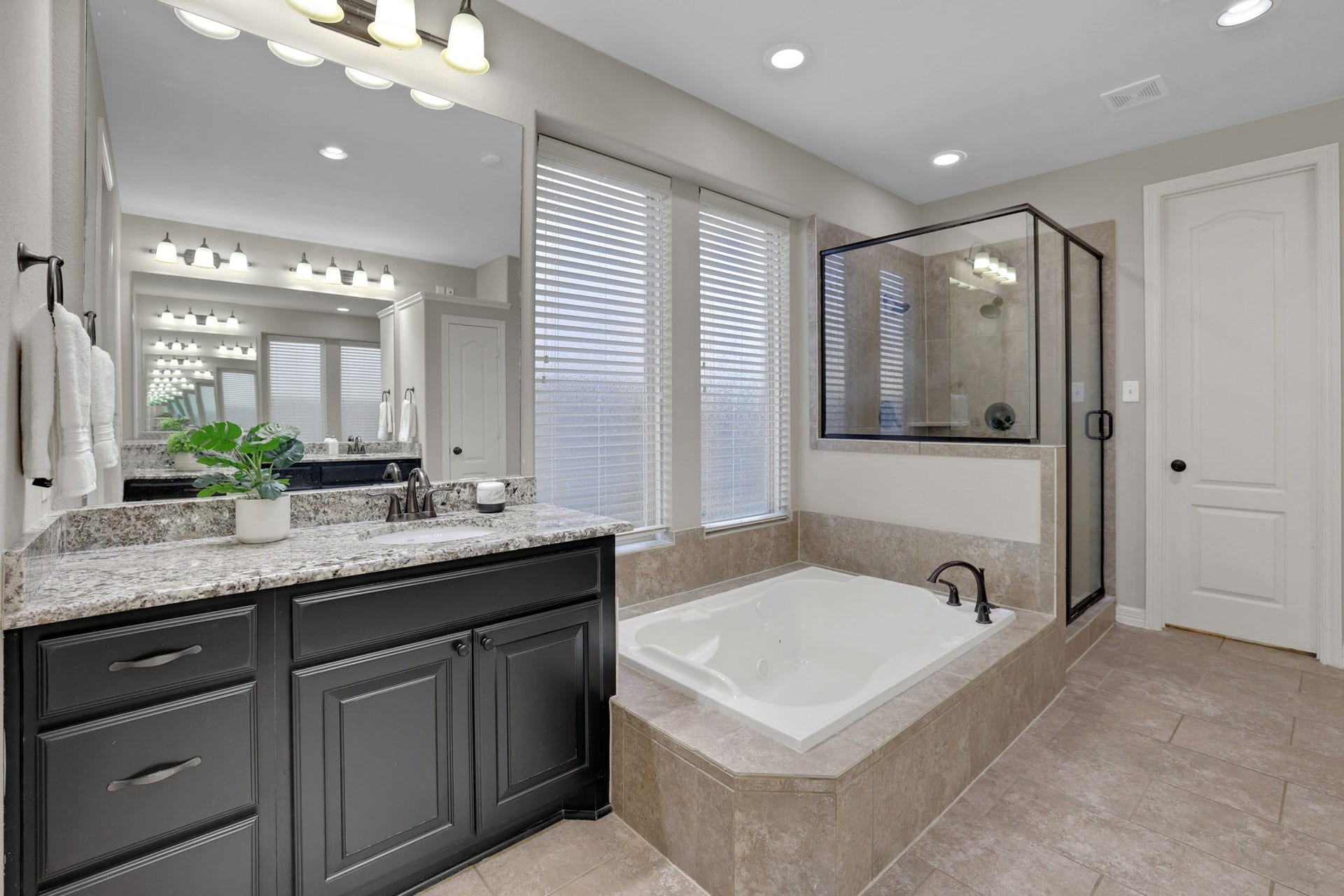 this primary bath has it all, with dual sinks and a vanity