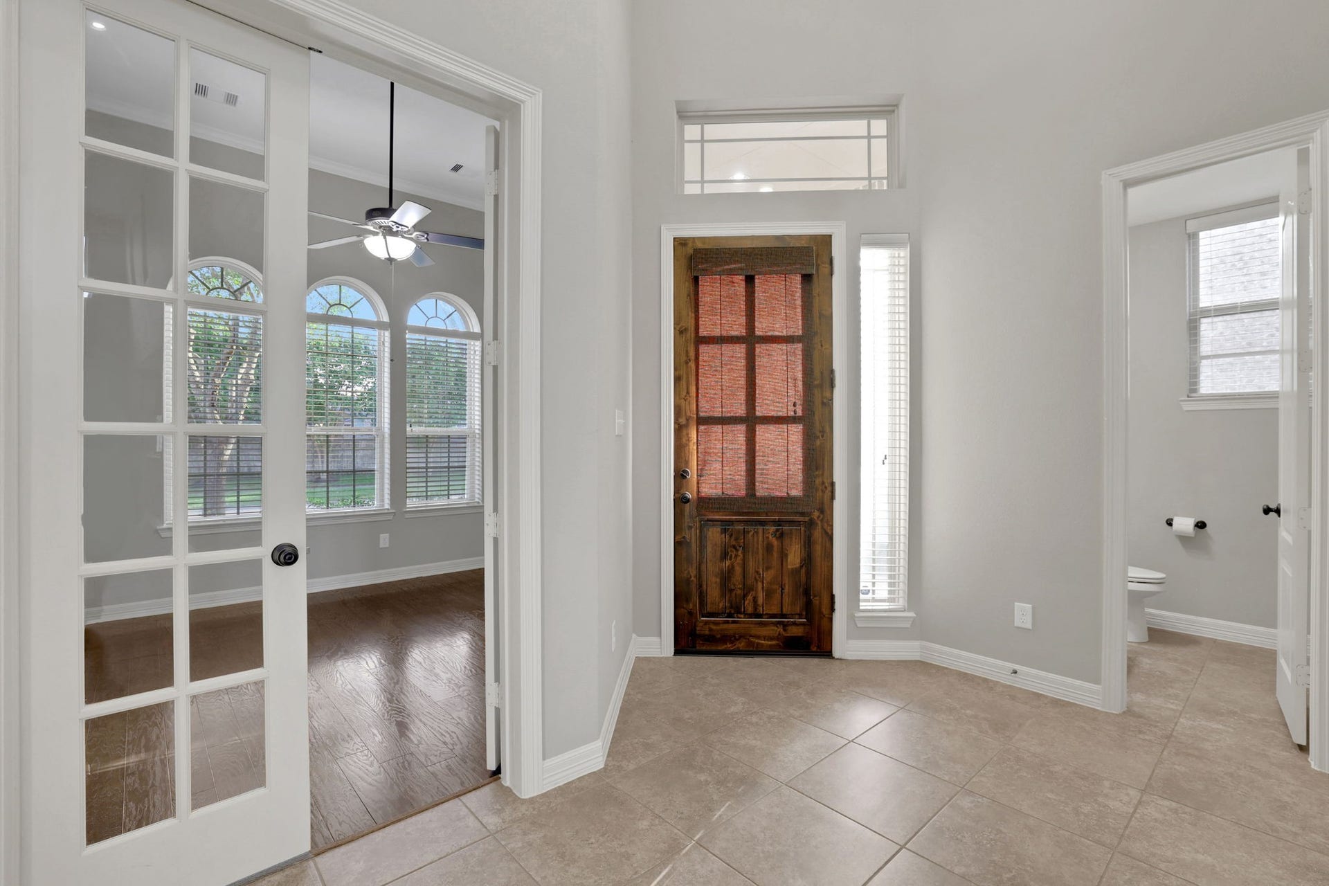Gorgeous entry with two high ceilings and the office tucked privately at the front of the home.