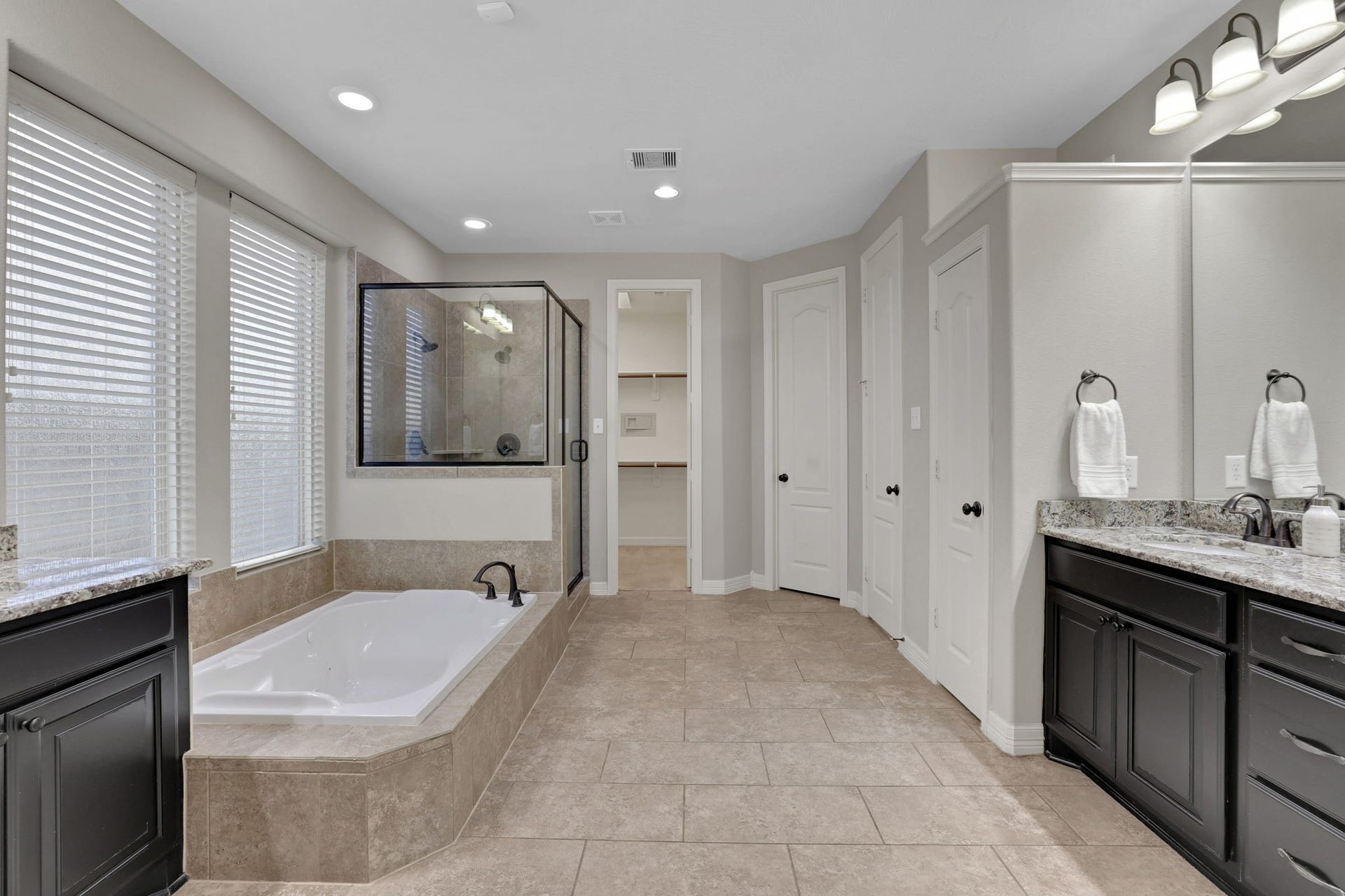 The primary bath features a soaking tub and separate shower