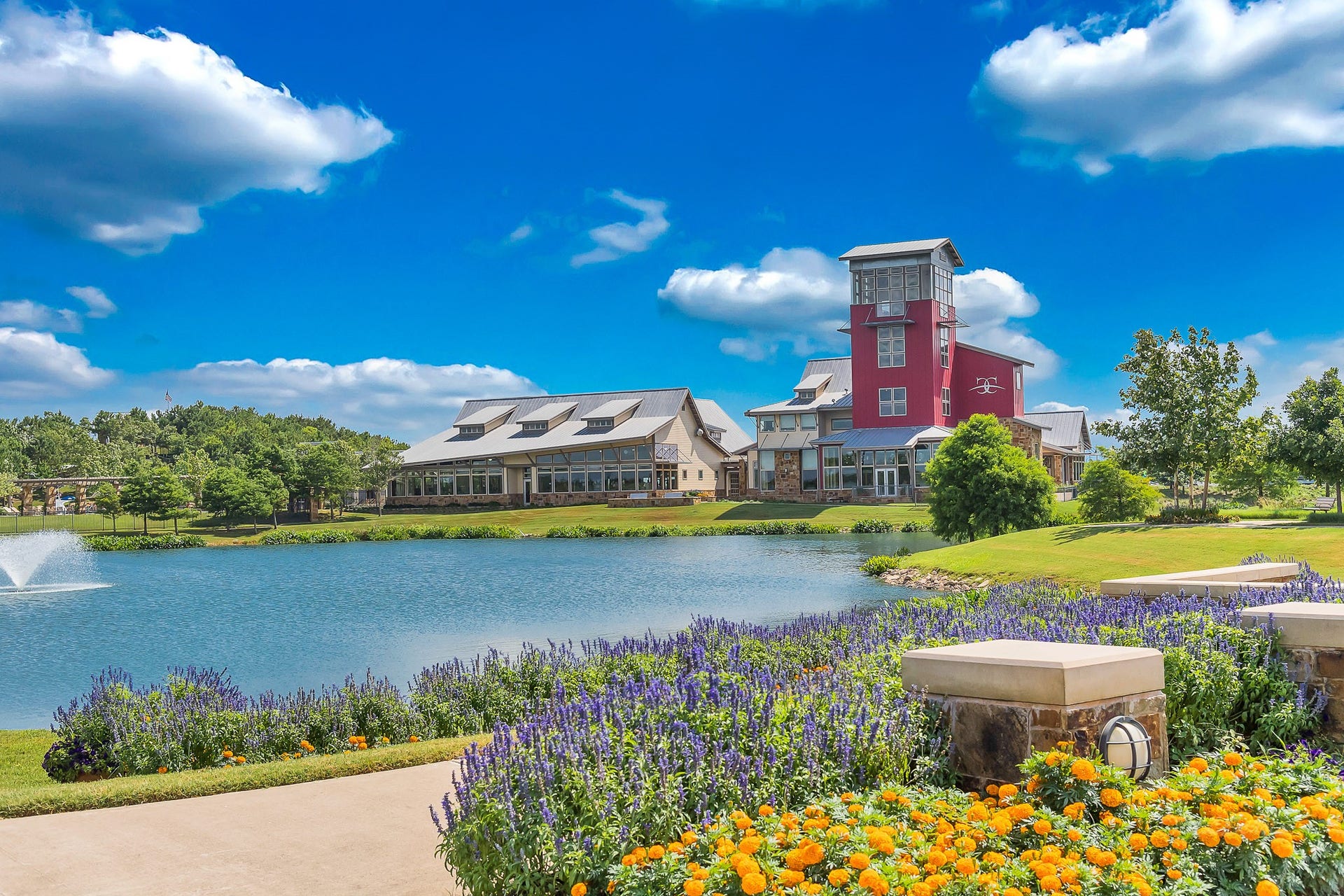The main amenity center at Cross Creek Ranch, home to Adventure Island Waterpark with its iconic 140-foot waterslide, resort-style pool, splash pad, and the communitys 6,500-square-foot fitness center.