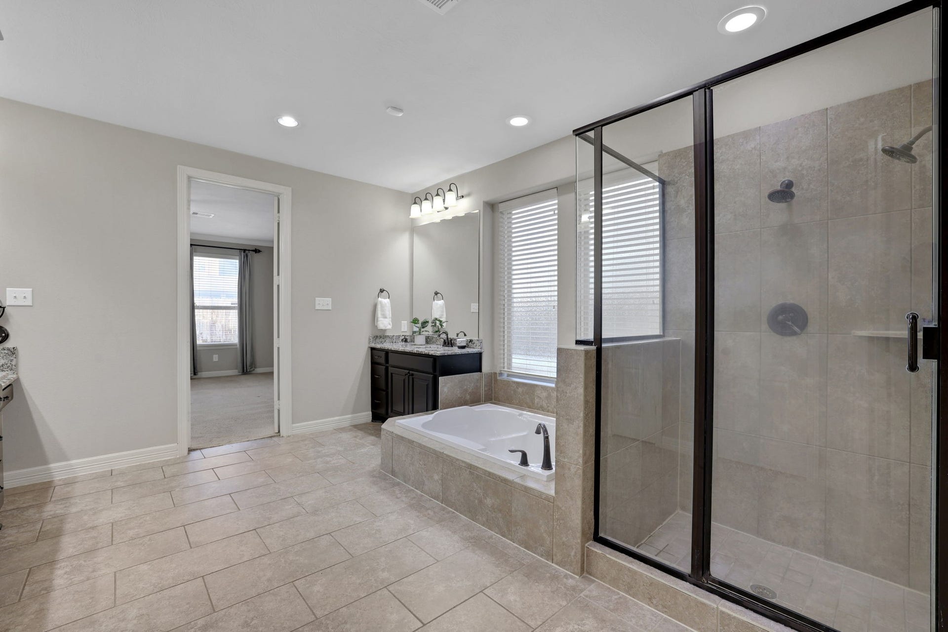 Another view of the primary bath featuring an oversized shower with dual shower-heads