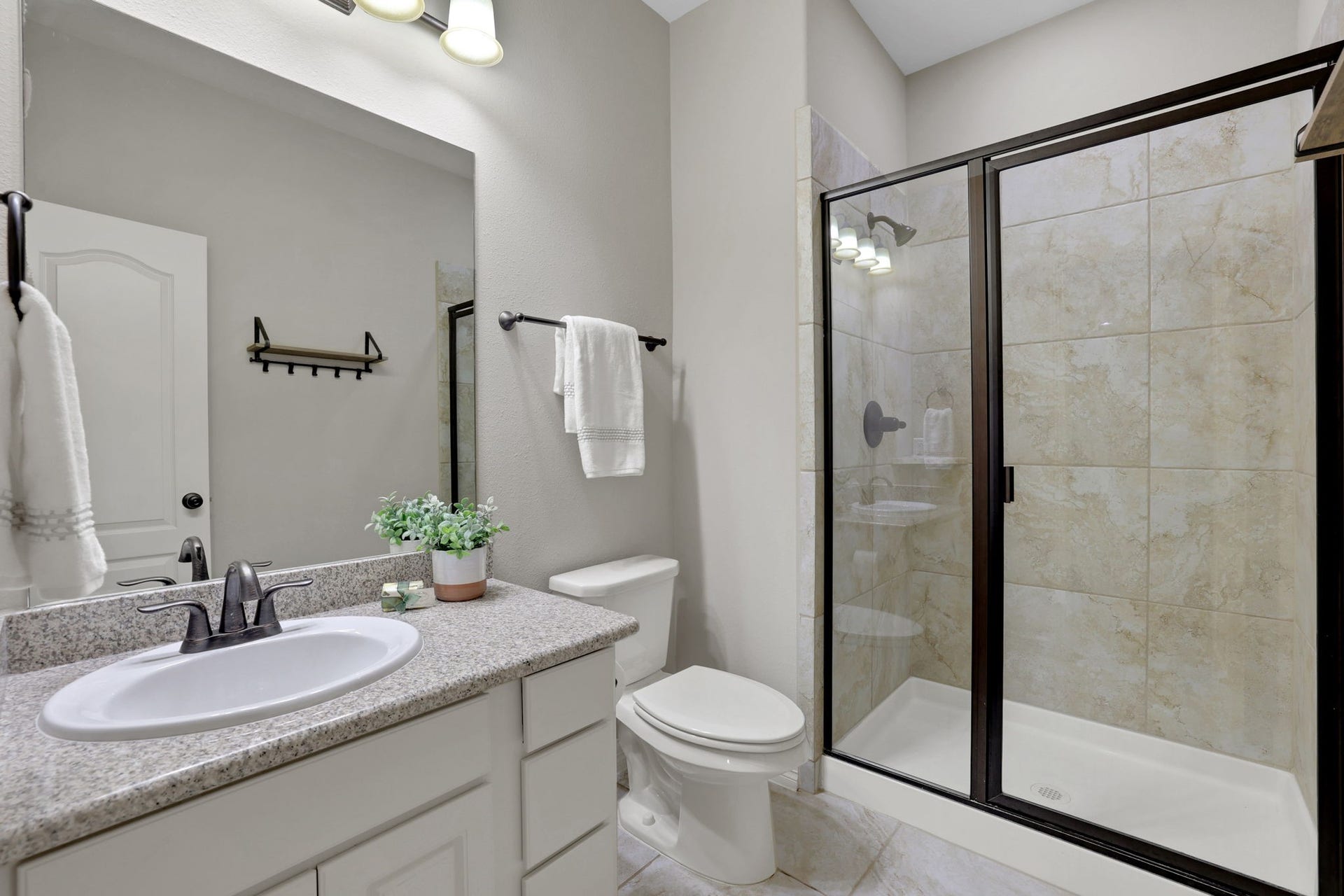 Another secondary bathroom upstairs with a standing shower