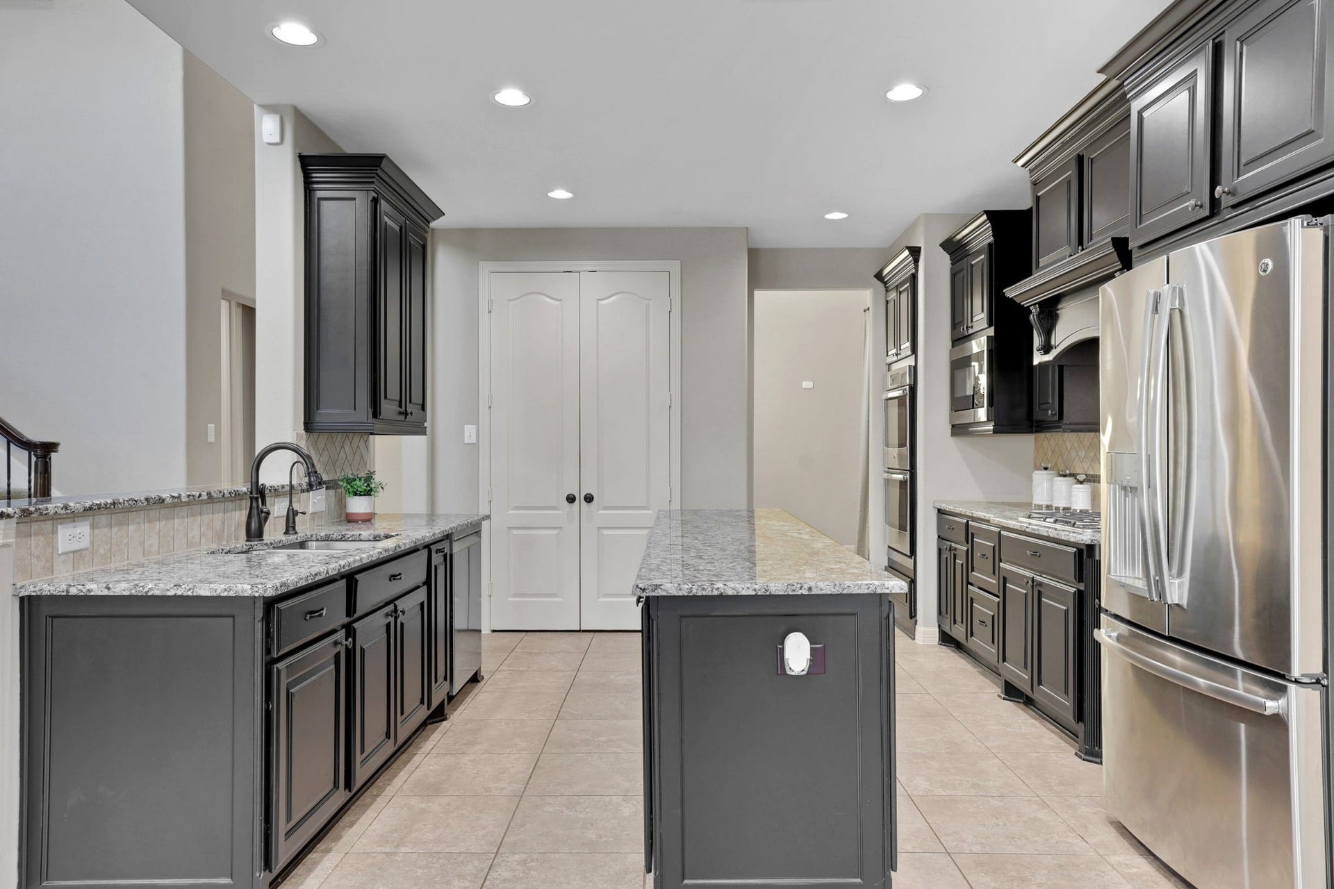 Another view of the kitchen with gorgeous granite countertops and stainless appliances
