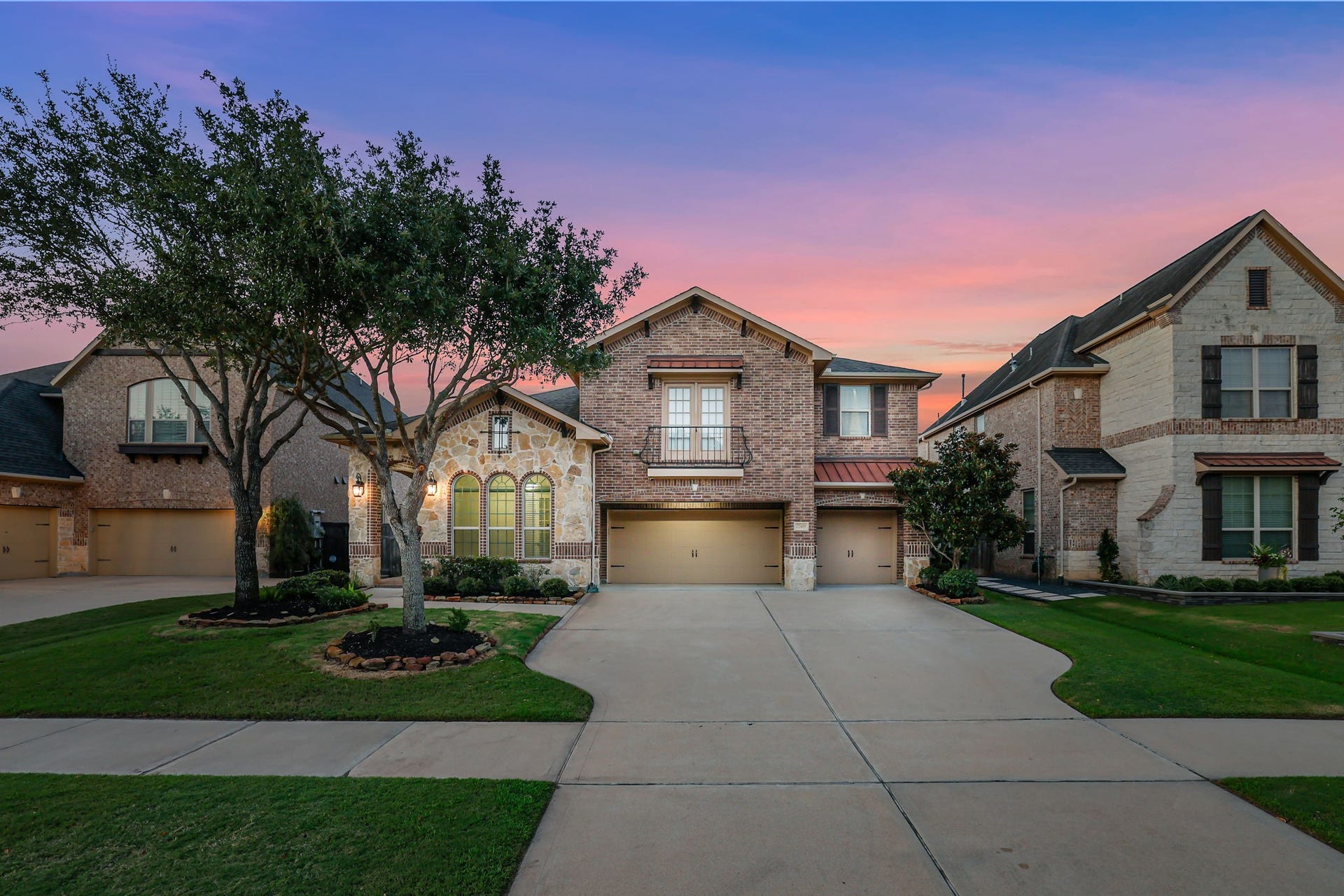 Stone and brick front elevation of this gorgeous Trendmaker Home with a 3-car garage!