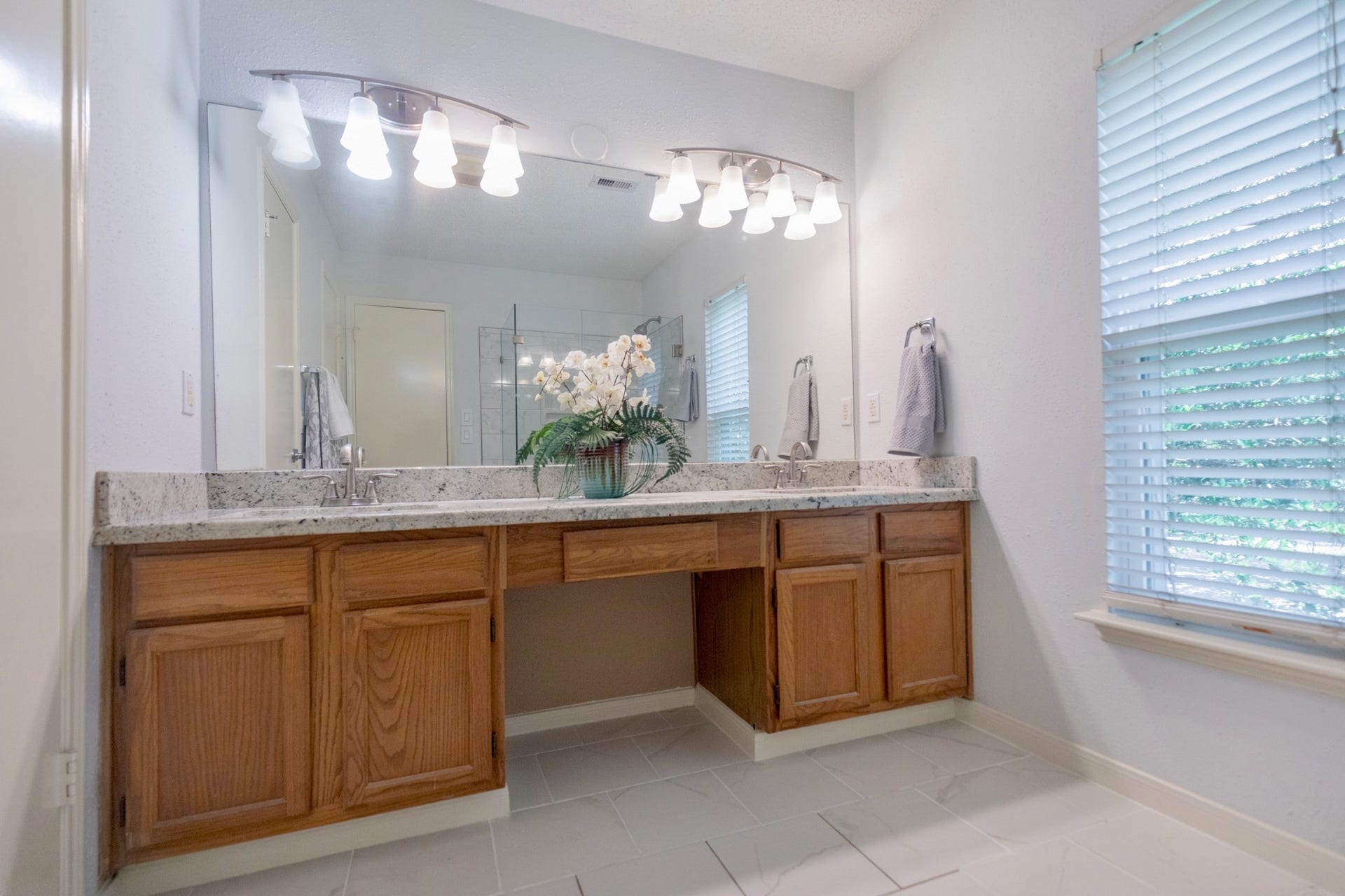 3007 Rimrock Drive, Missouri City, TX 77459 THE PRIMARY BATHROOM BOASTS EXQUISITE CUTS OF GRANITE AND IS WARMED BY STAINLESS SCONCE LIGHTING!!!
