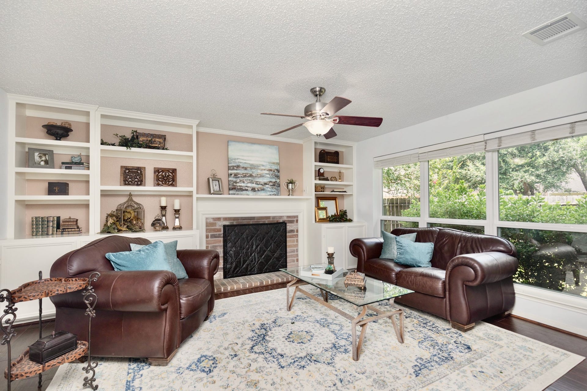 3007 Rimrock Drive, Missouri City, TX 77459 OPENING FROM THE KITCHEN, THE LIVING ROOM FEATURES QUALITY BUILT-INS CENTERED AROUND A COZY FIREPLACE, WITH A WALL OF WINDOWS SUPPLYING AMPLE NATURAL LIGHT!!!